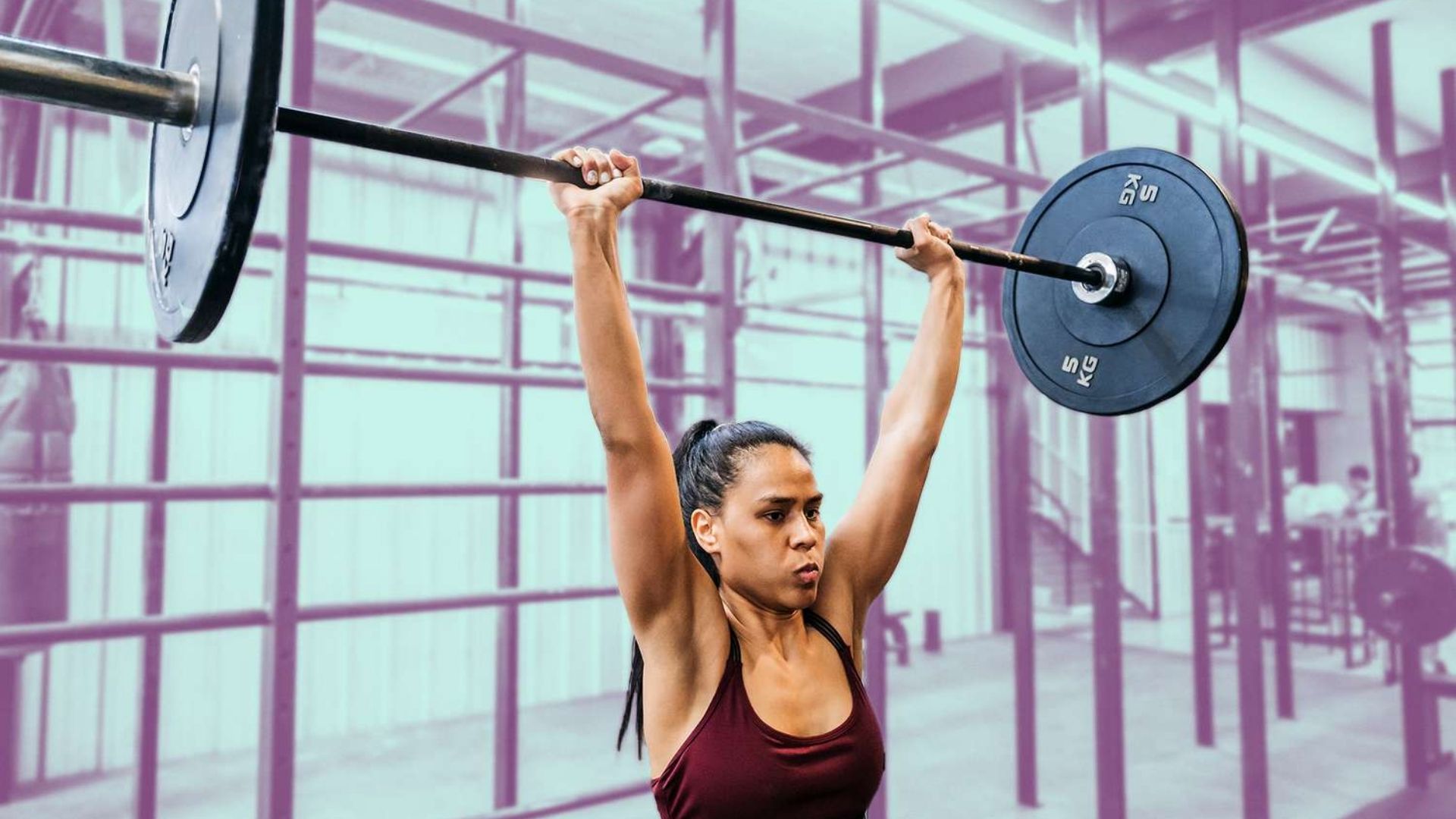A woman performs a barbell lift in a gym, highlighting her commitment to physical fitness and strength development.