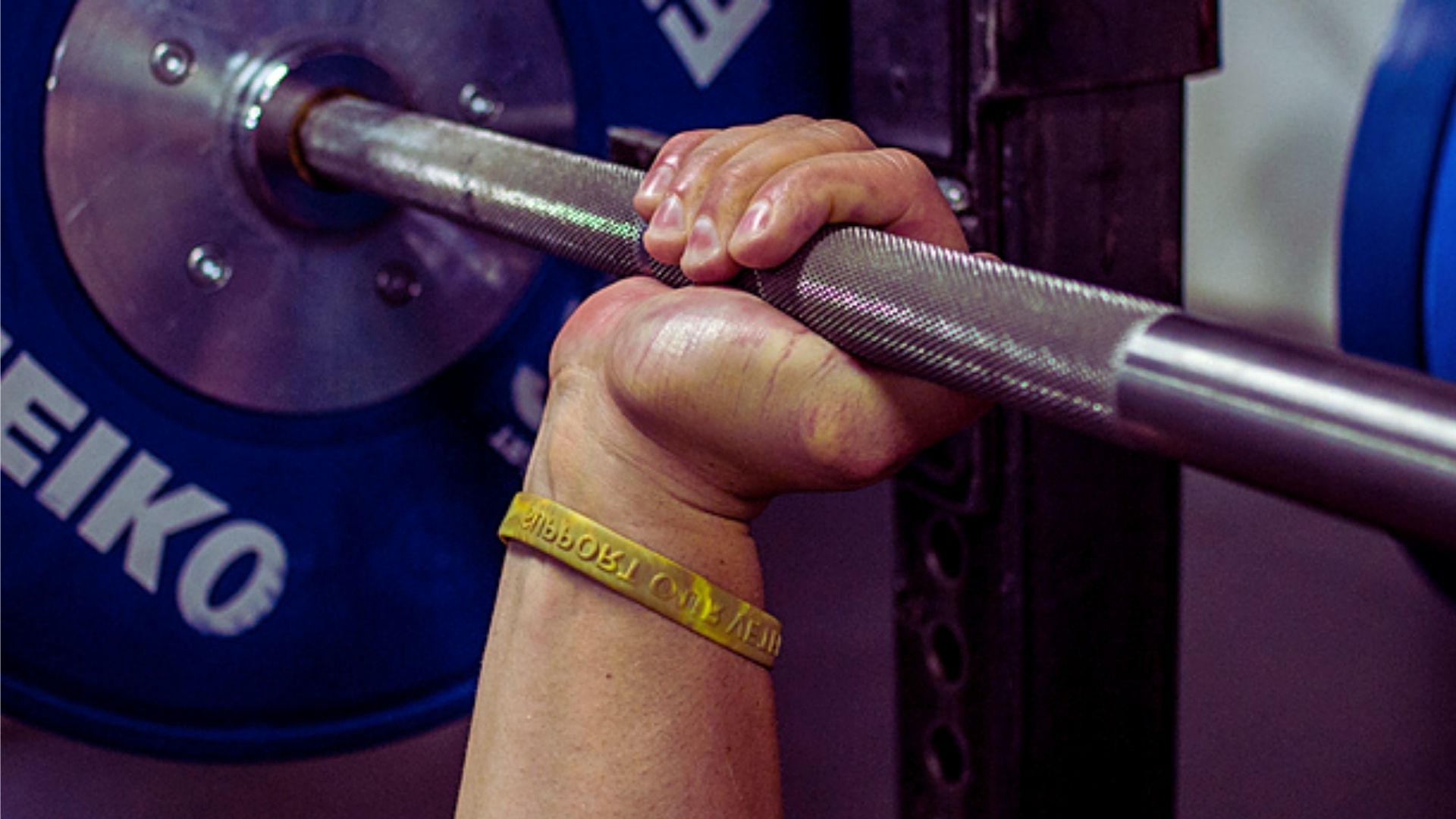 1. A person lifts a barbell in a gym, focusing on strength training and fitness.