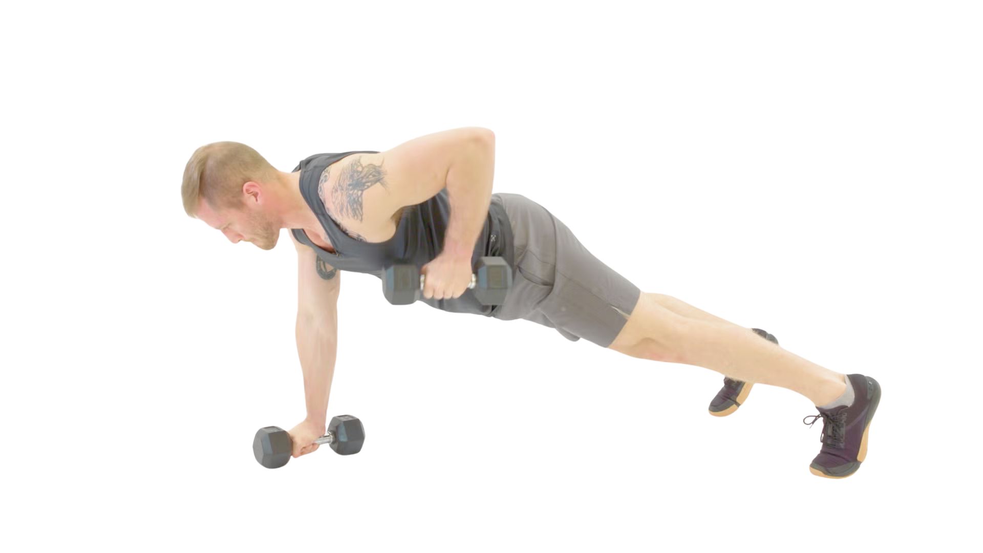 A man performs push-ups while holding dumbbells, focusing on strength training and fitness.