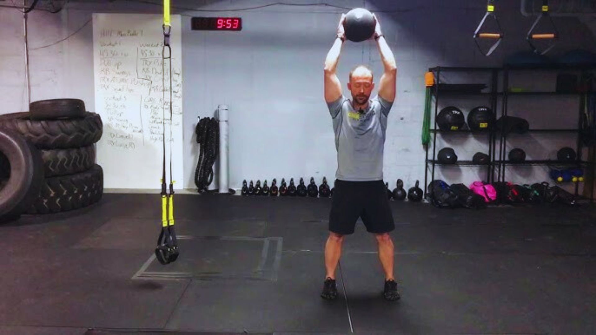 A man in a gym holding a kettlebell, demonstrating his commitment to fitness and strength training.