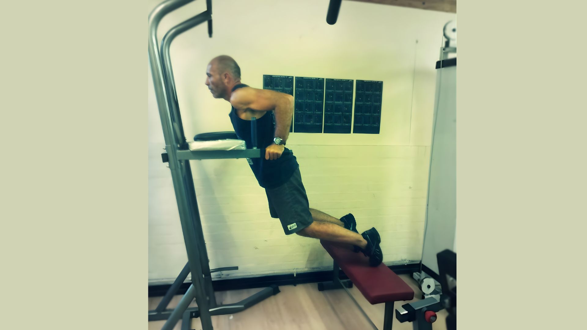 A man performing a pull-up on a machine, showcasing strength training and upper body exercise technique.