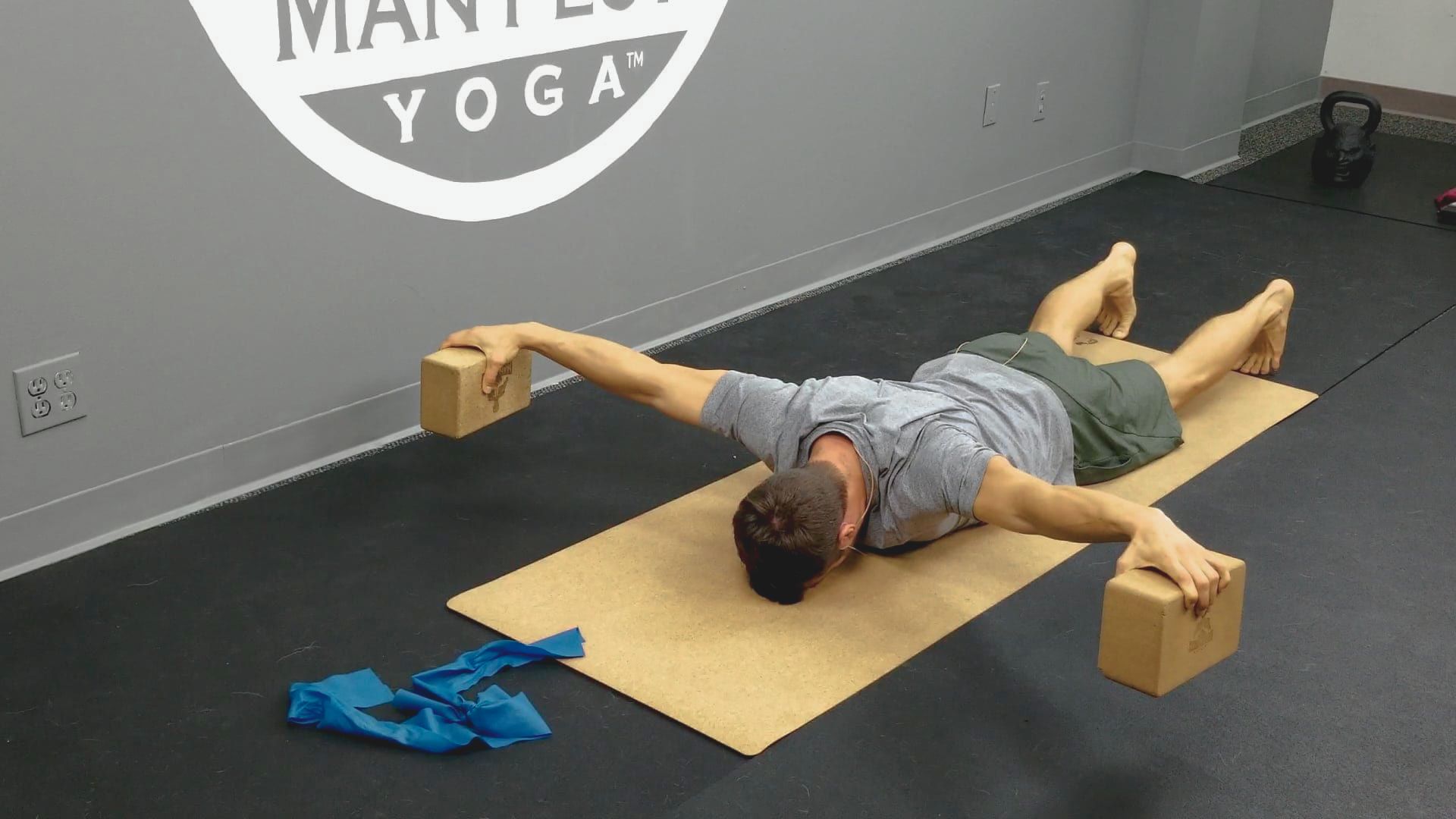 Man in a plank position on a mat, demonstrating strength and balance during a workout session.