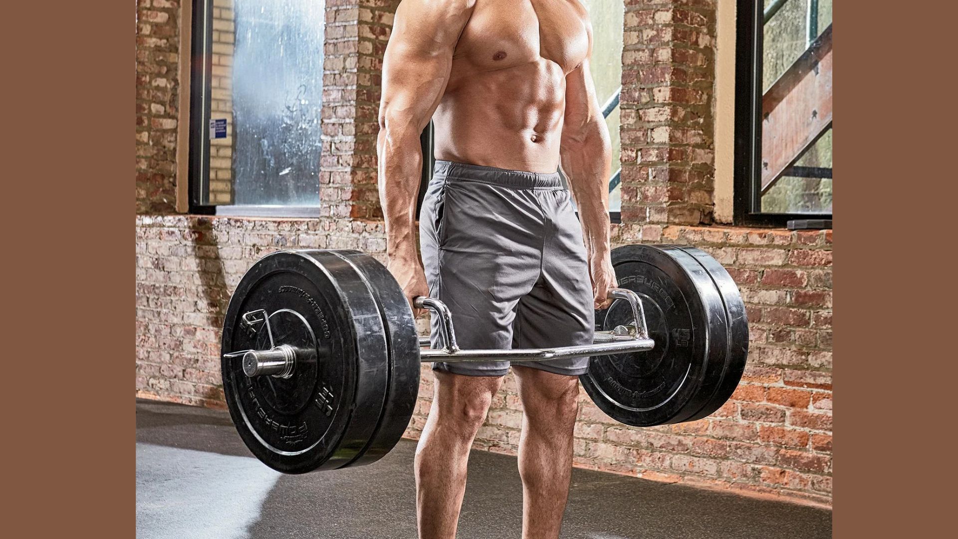 A man is lifting a barbell while exercising in a gym, focusing on strength training.