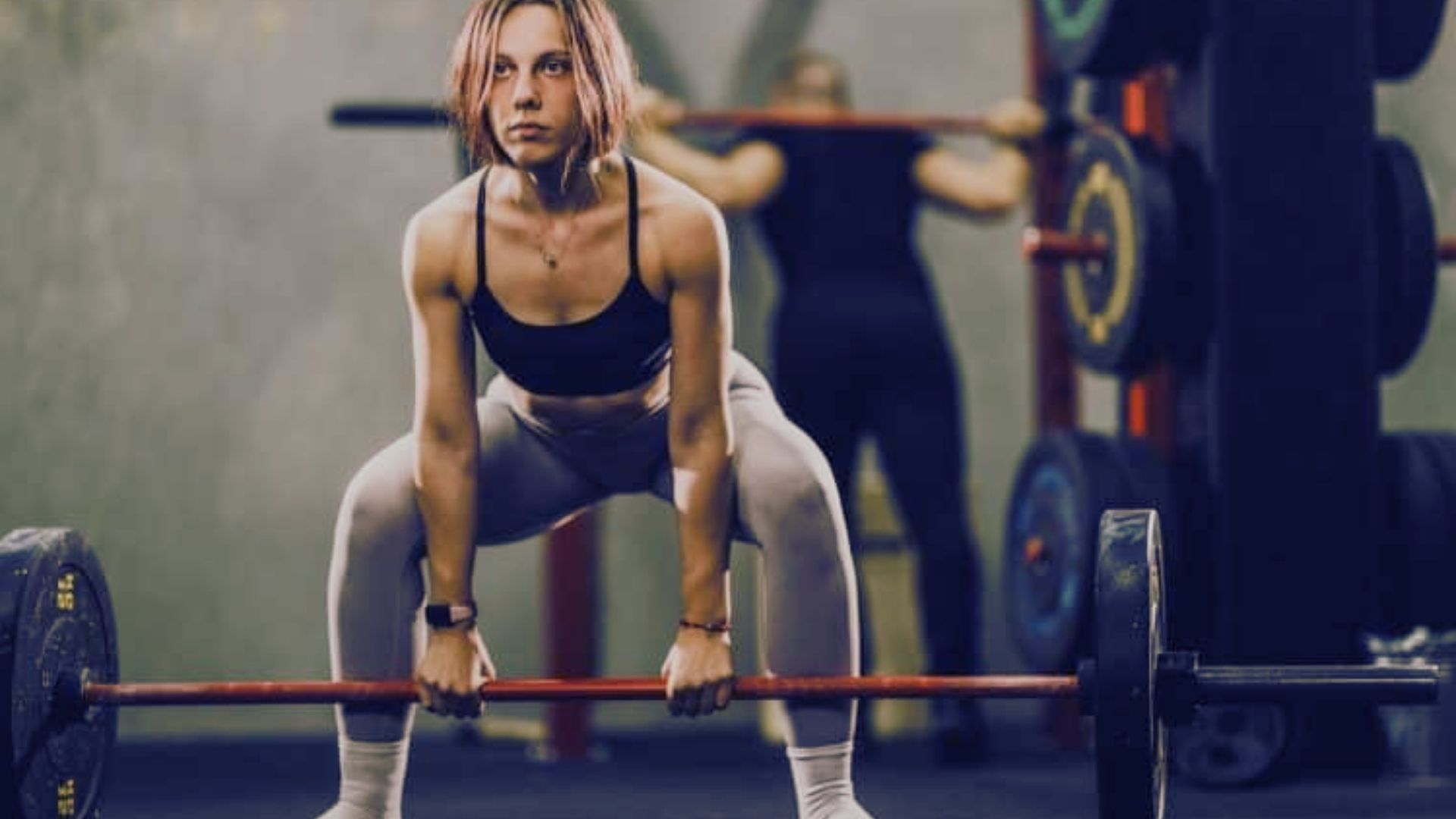 A black barbell resting on a black barbell, illustrating a 315-pound deadlift setup.