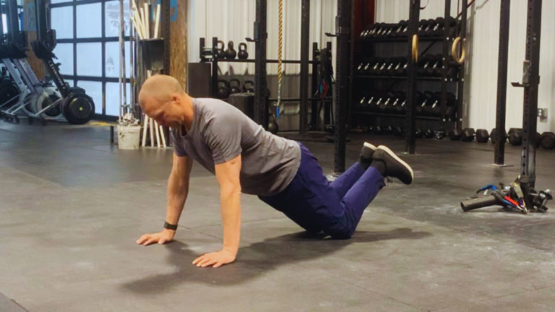 2. A man engaged in a push-up exercise on the floor, showcasing physical activity.