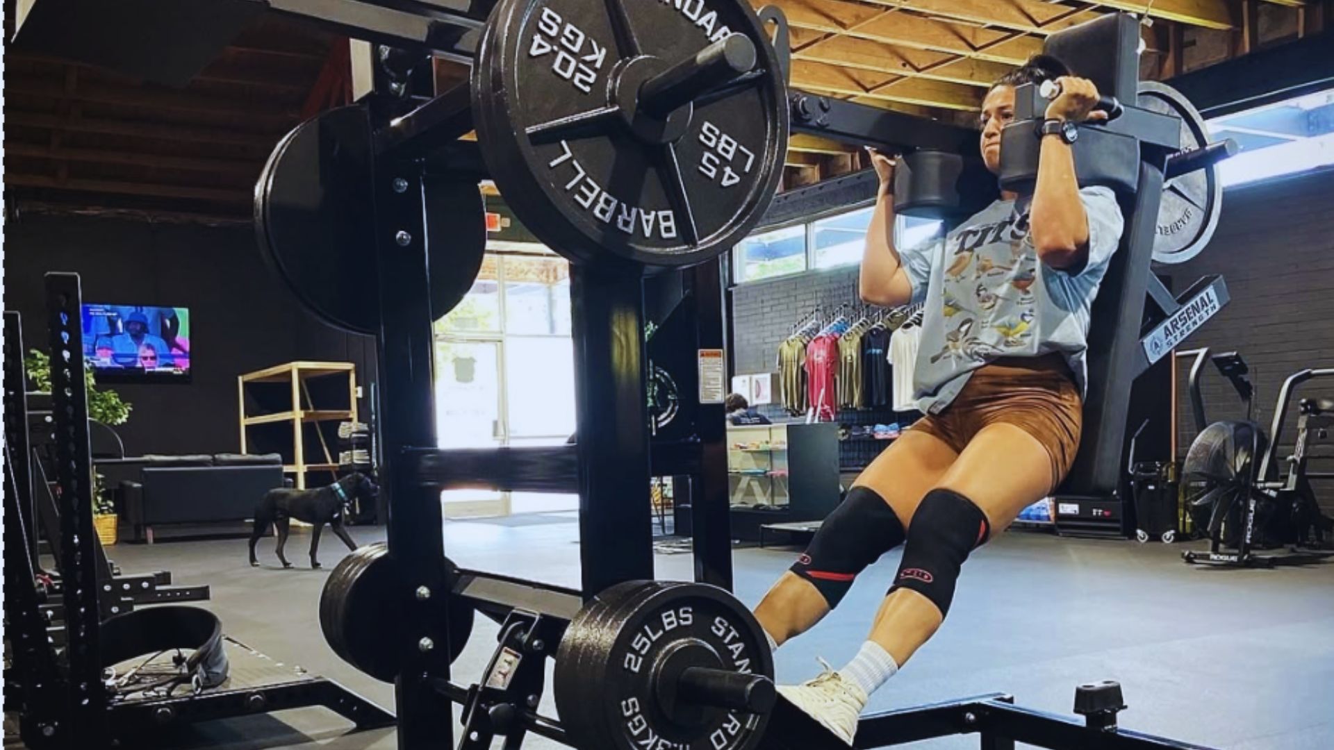 2. A woman is engaged in squats at a gym, demonstrating her fitness routine and dedication to exercise.
