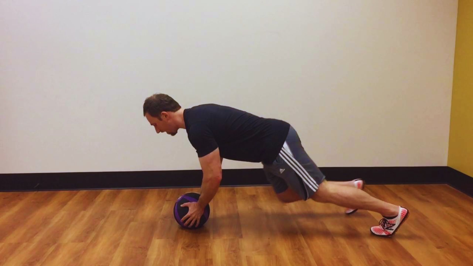 A man balances on a stability ball while doing a push-up, highlighting his strength and coordination.