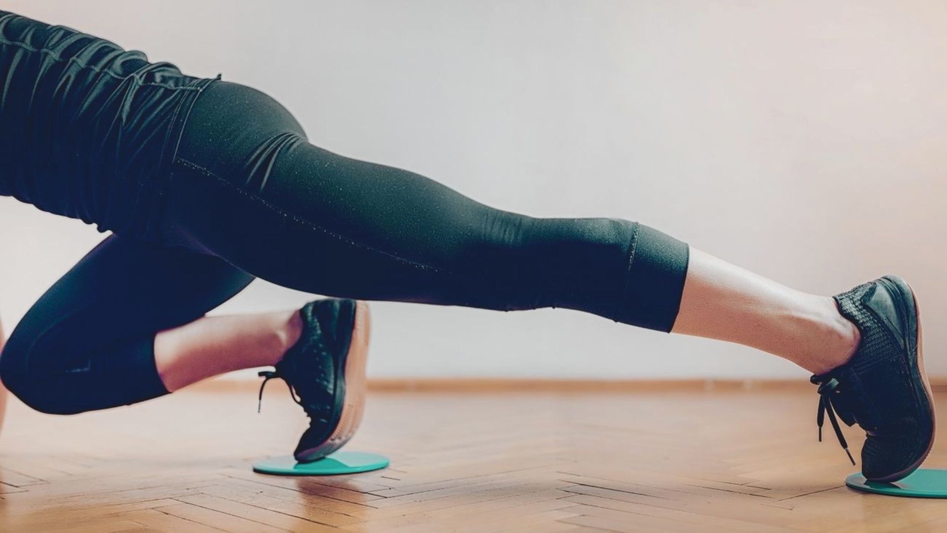A woman is engaged in push-ups on a vibrant green mat, demonstrating her fitness routine.