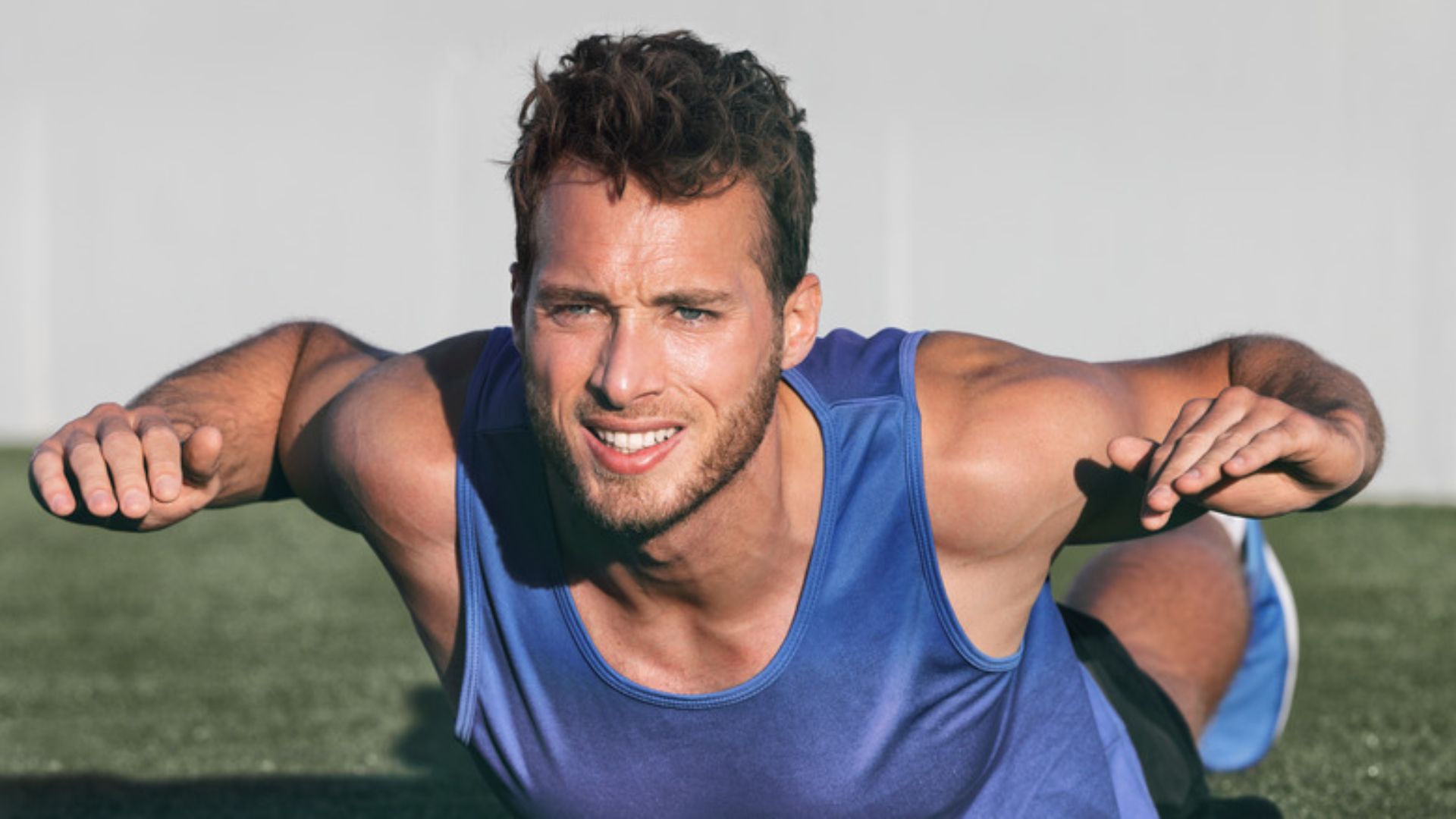 A man performing push-ups on the ground, focusing on his exercise routine