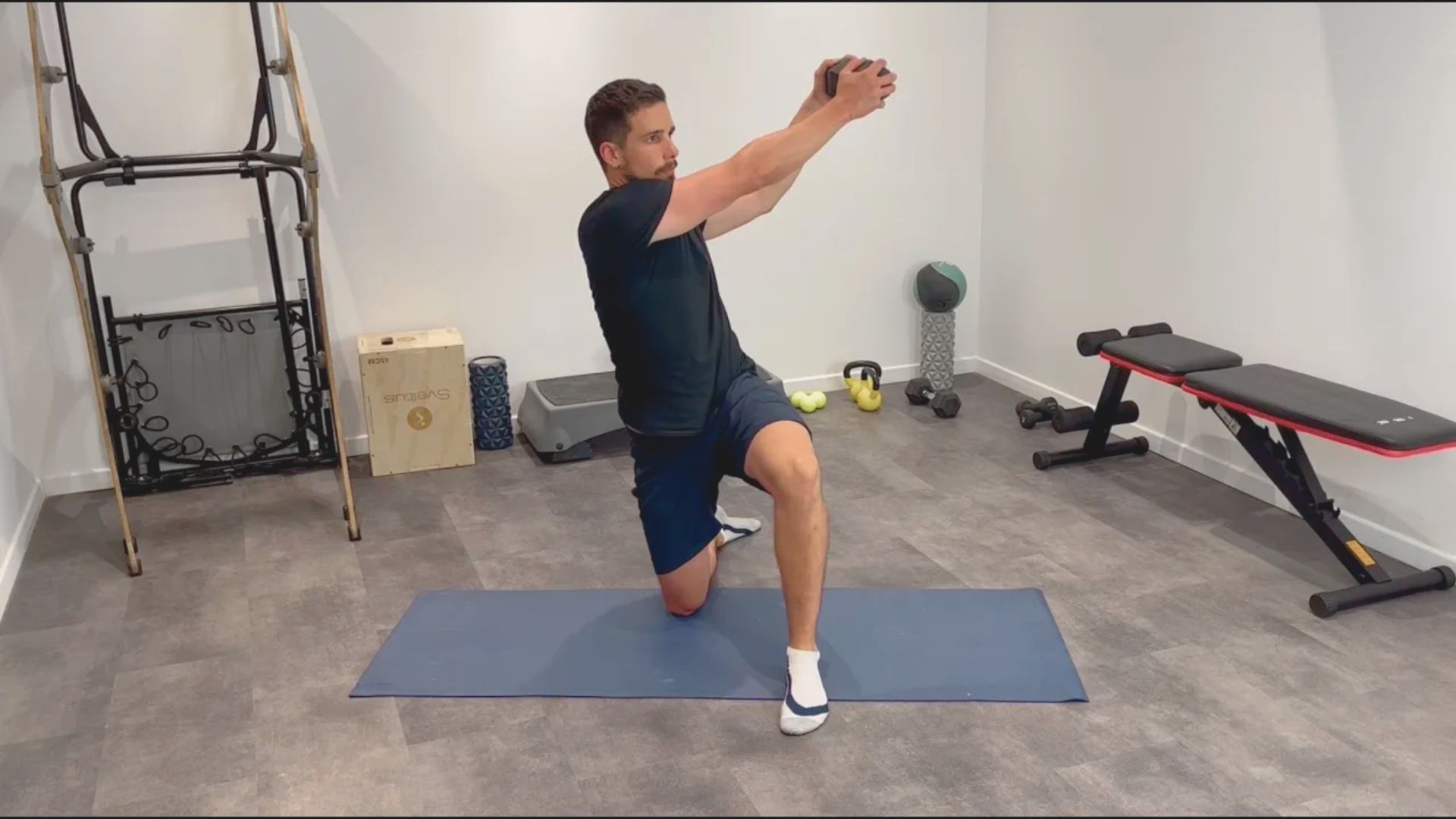 A man performs a squat in a gym, focusing on his form and strength training.