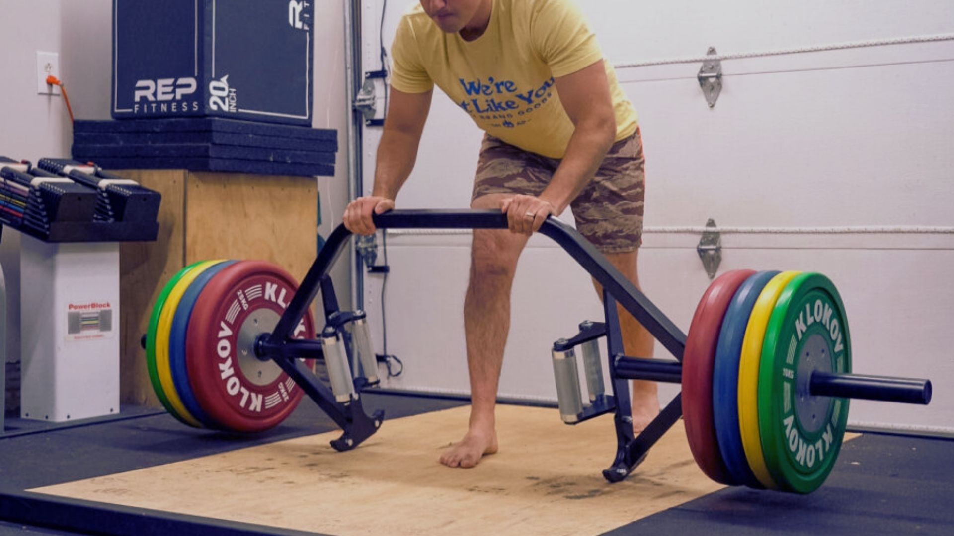 A man lifts a barbell on a weight bench, demonstrating strength training for home gym setups.
