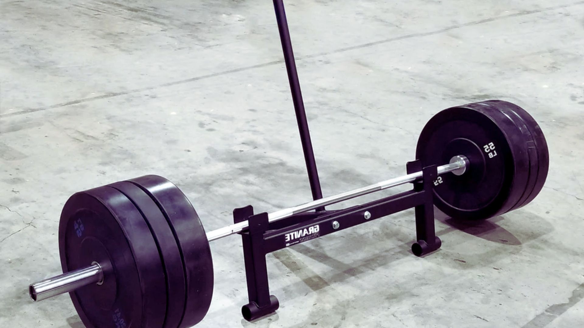 A black barbell resting on a black barbell, illustrating a 315-pound deadlift setup.