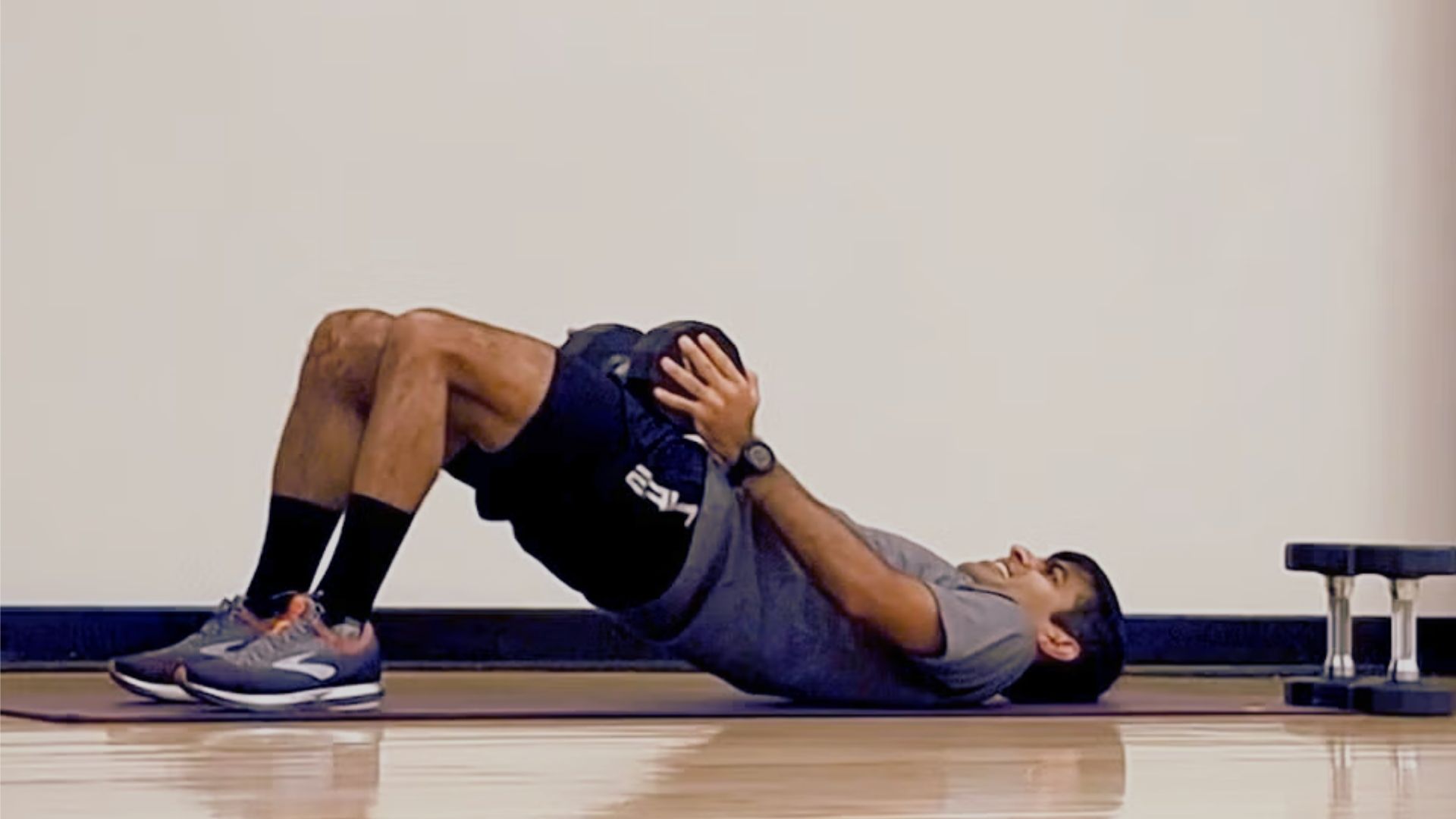A man is engaged in a push-up on a mat, showcasing his exercise routine and physical fitness.
