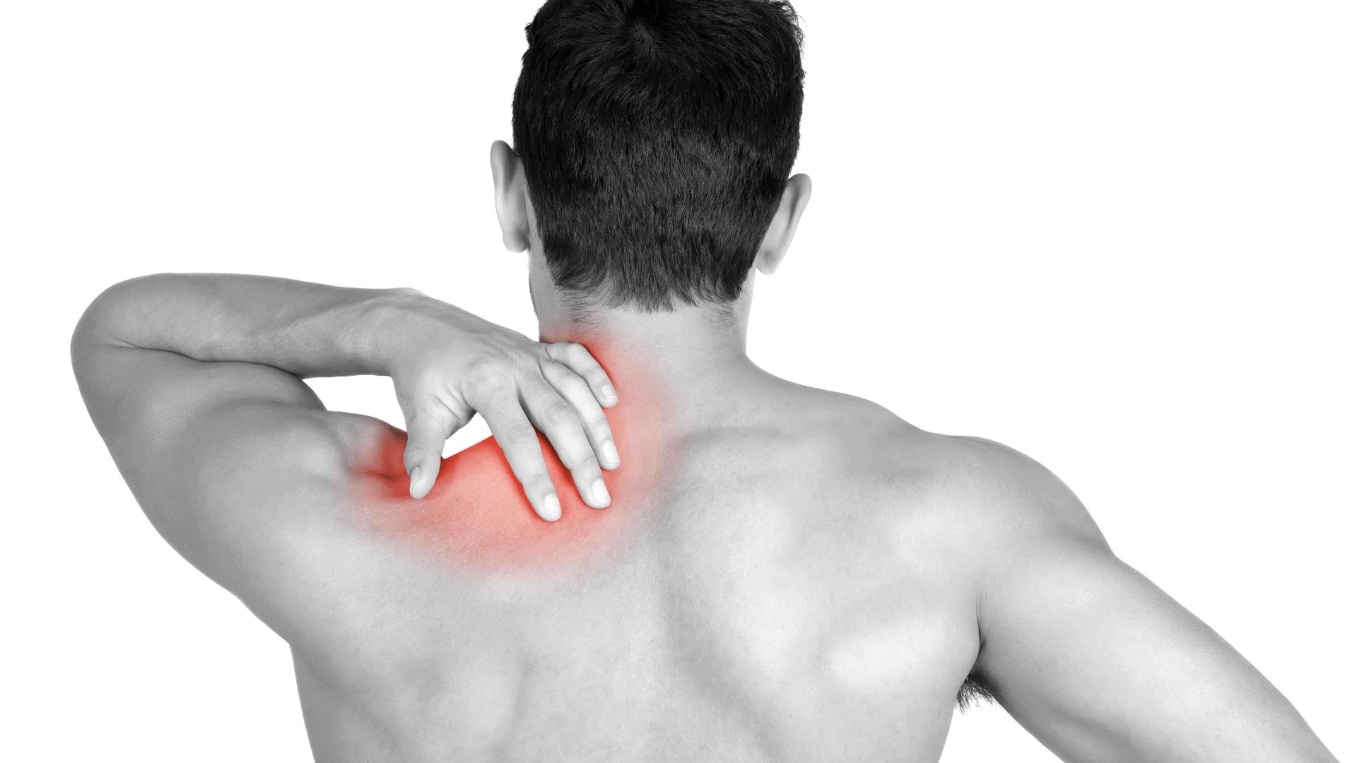 A man grimaces, holding his upper back and shoulder, indicating pain in the trapezius area.