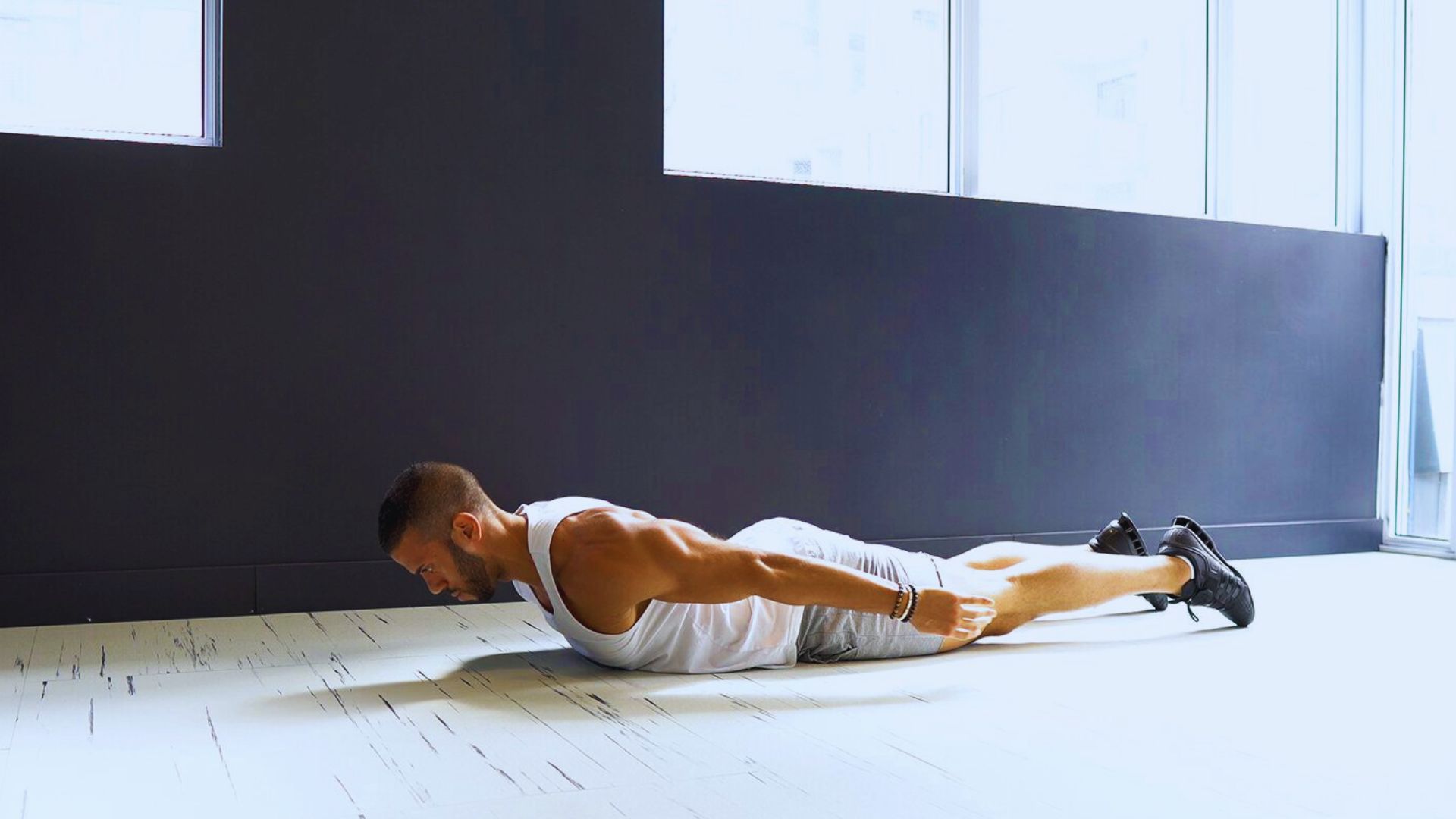 A man performing a push-up on the floor, demonstrating strength and fitness.