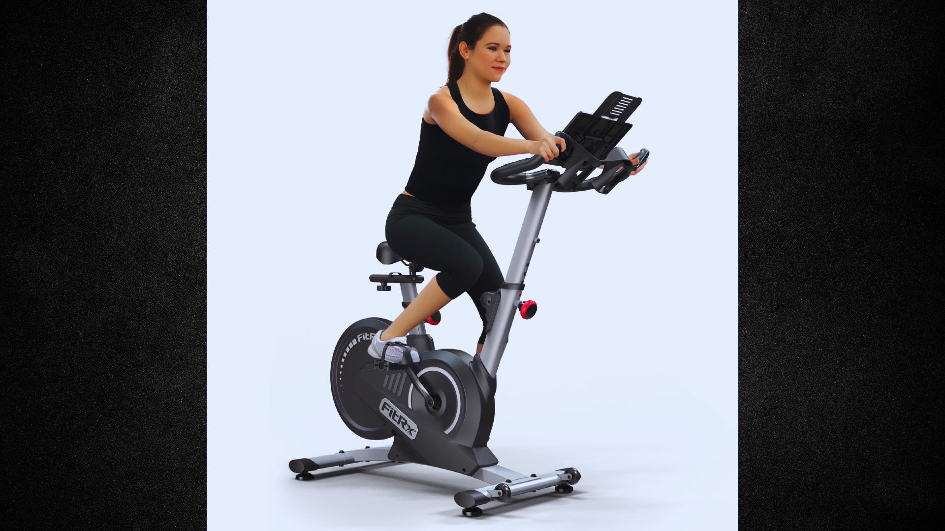 A woman exercises on a stationary bike against a plain white background.