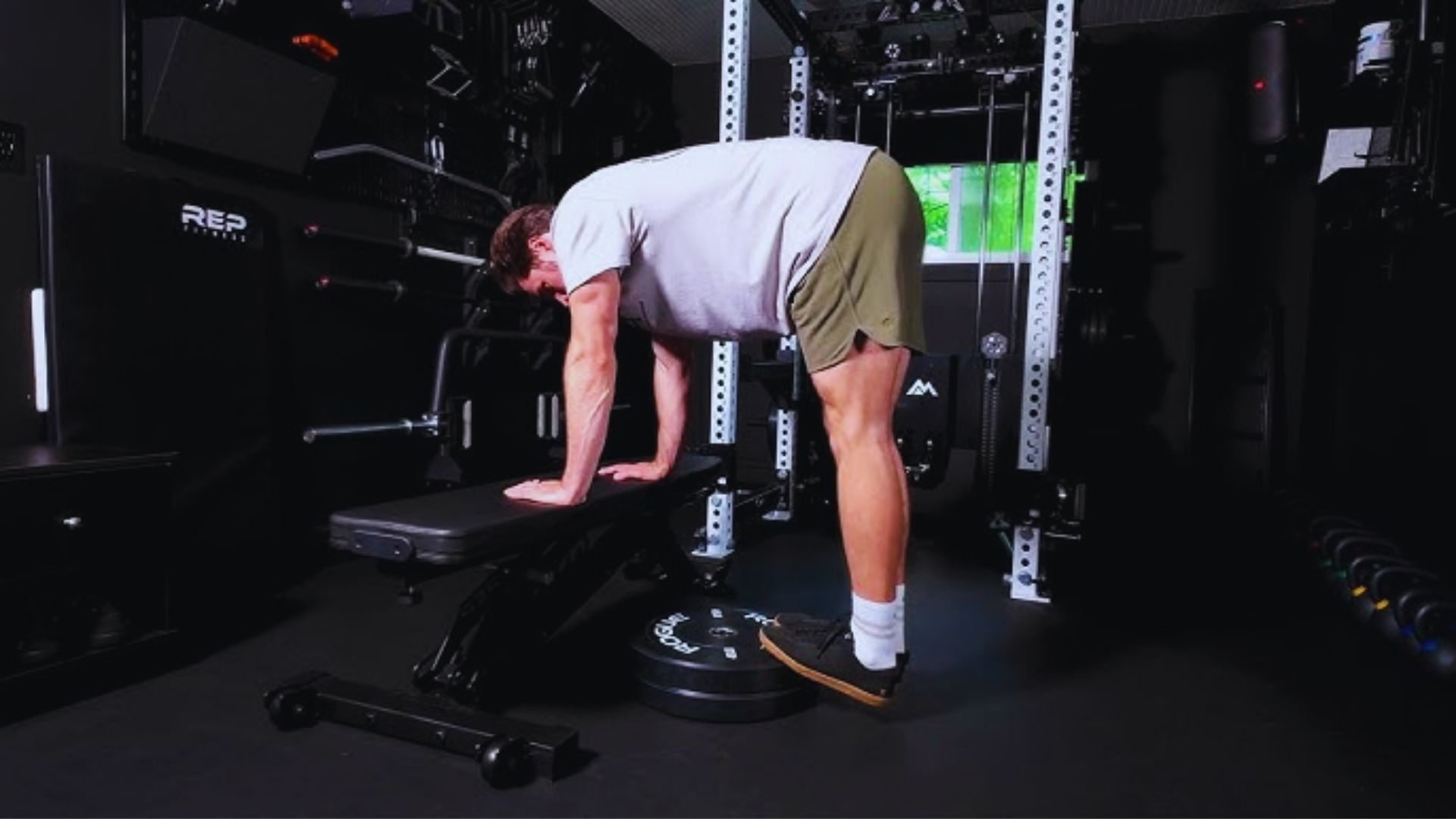 A man performing a squat in a gym, focusing on strength training with weights.
