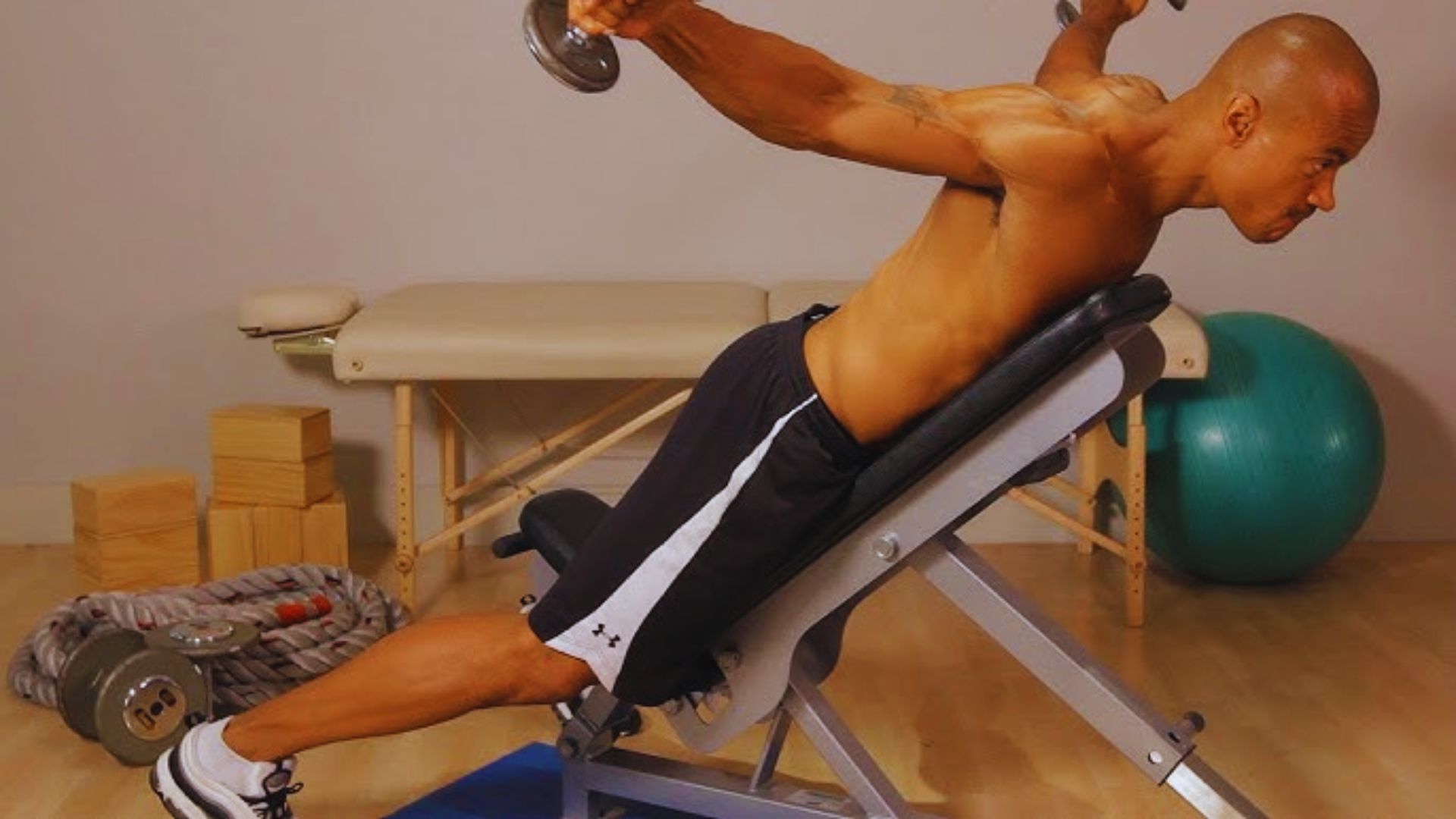 A man performs a push-up on a bench, demonstrating strength and fitness in an outdoor setting.
