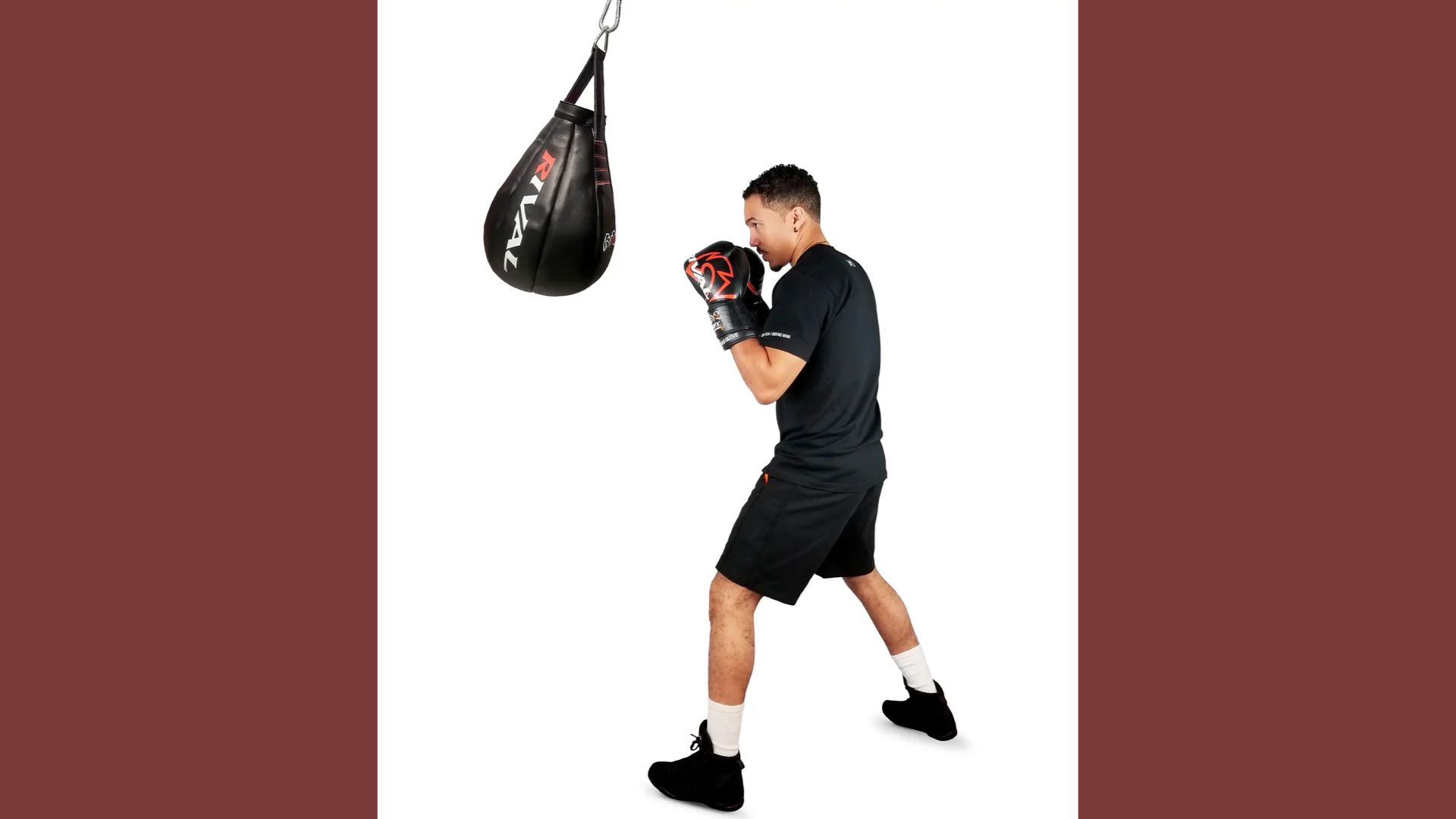 A man stands in front of a punching bag, preparing to train or practice his boxing skills.
