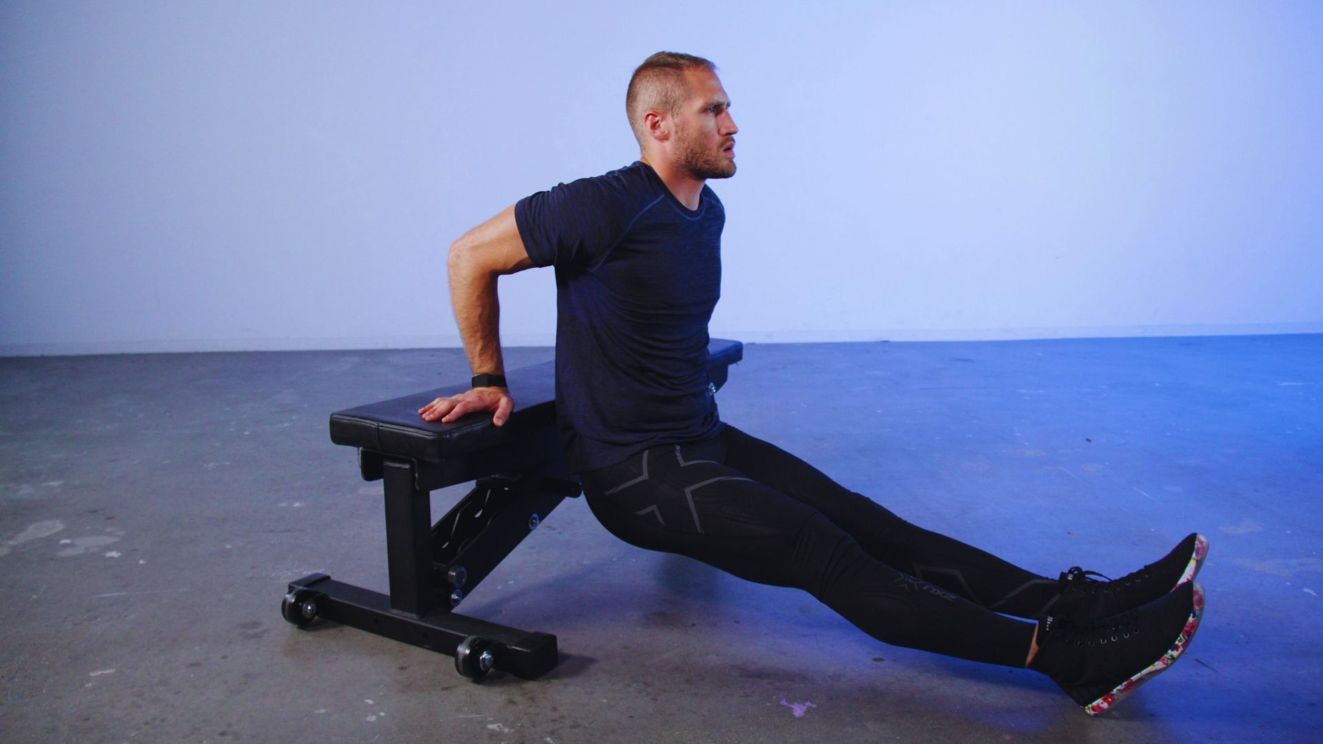 A man is executing a sit-up on a bench, emphasizing his commitment to fitness and core workout.