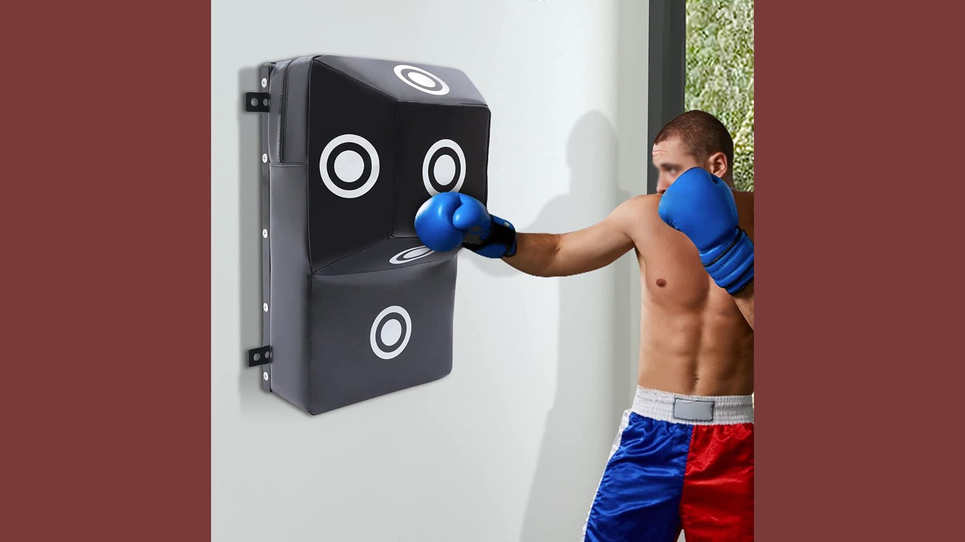 A man in boxing gear strikes a punching bag with focused intensity during a training session.