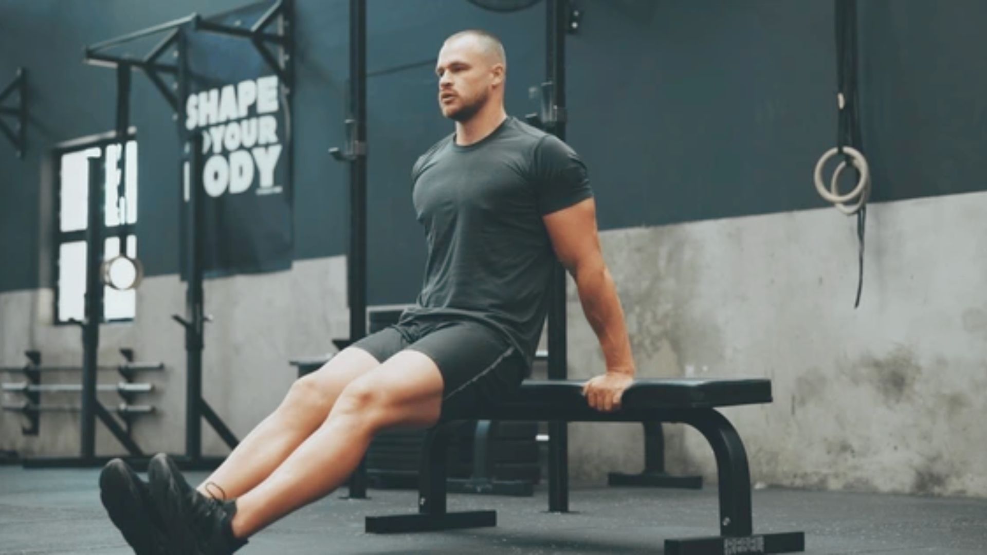 A man performs a sit-up on a bench, focusing on his core strength and fitness routine.