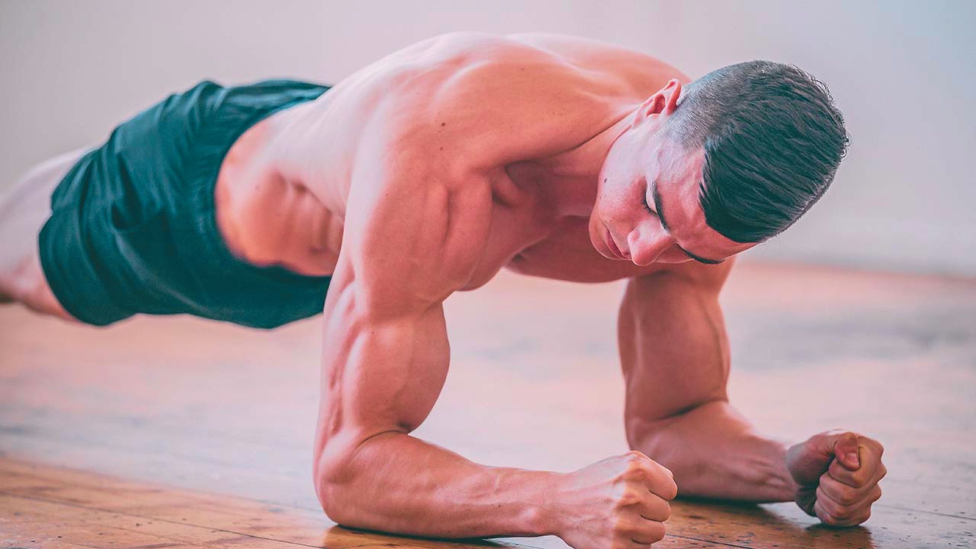 A man performing push-ups on the floor, focusing on his strength and fitness routine.