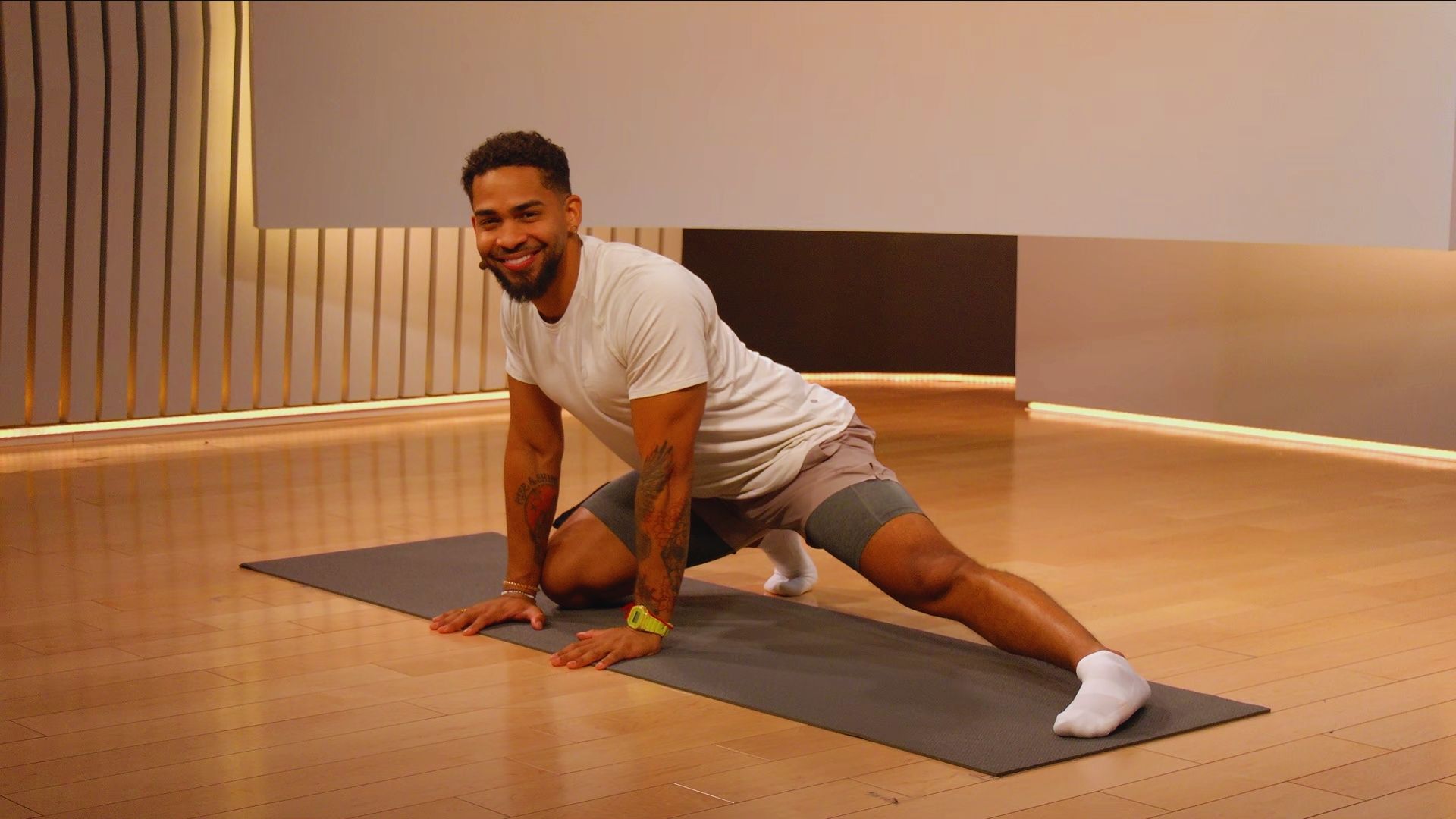 A man practicing a yoga pose on a mat, demonstrating balance and focus in a serene environment.