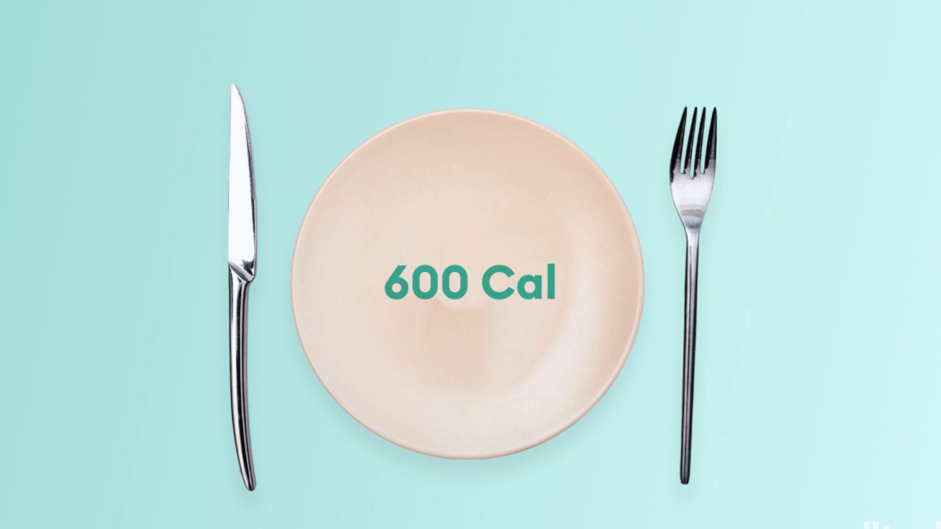 A pale orange plate with "600 Cal" text is centered between a silver knife and fork against a light teal background, conveying a minimalist, dietary theme.