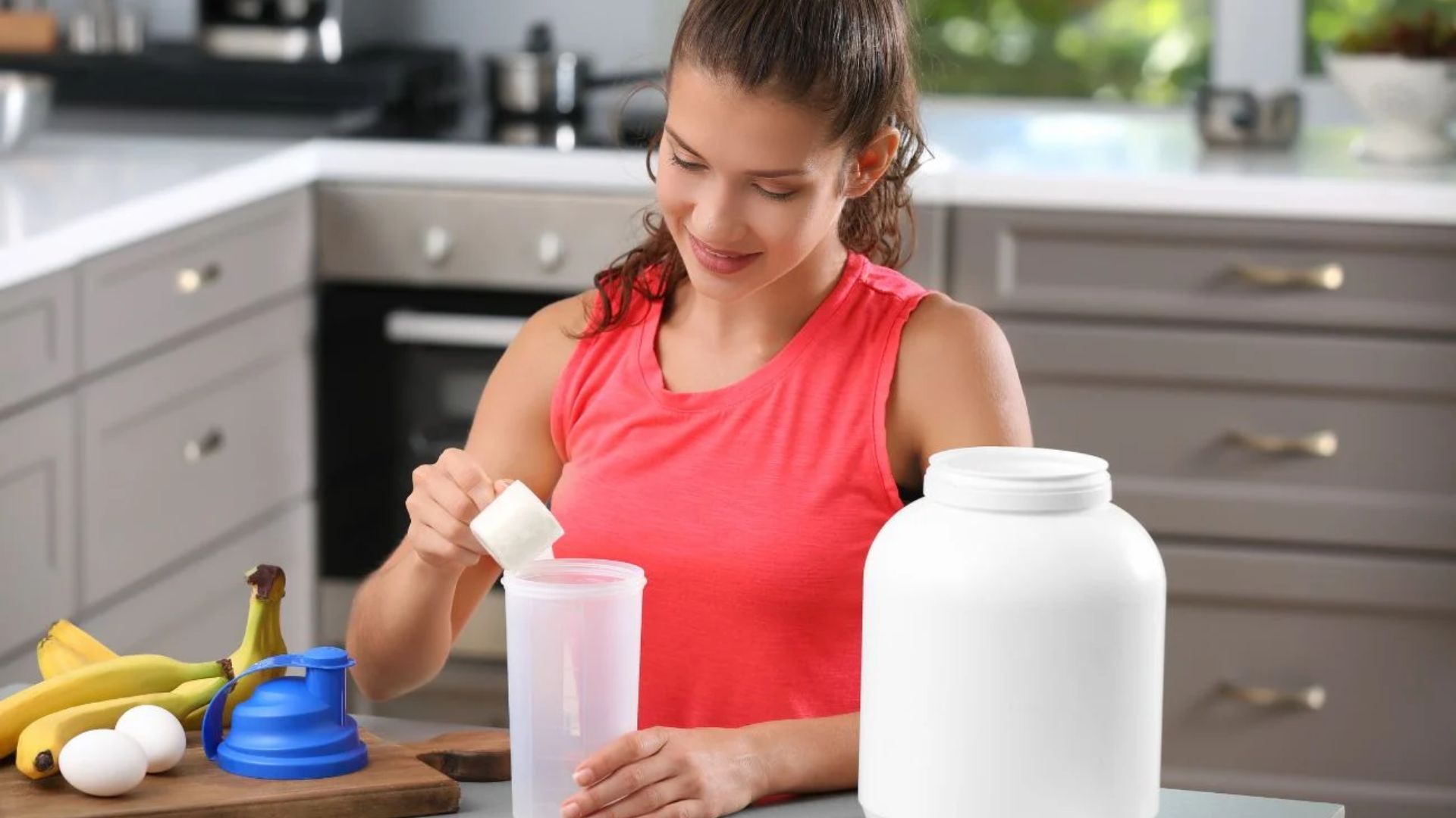 A woman mixes protein powder in a jar, focusing intently on blending the ingredients thoroughly.
