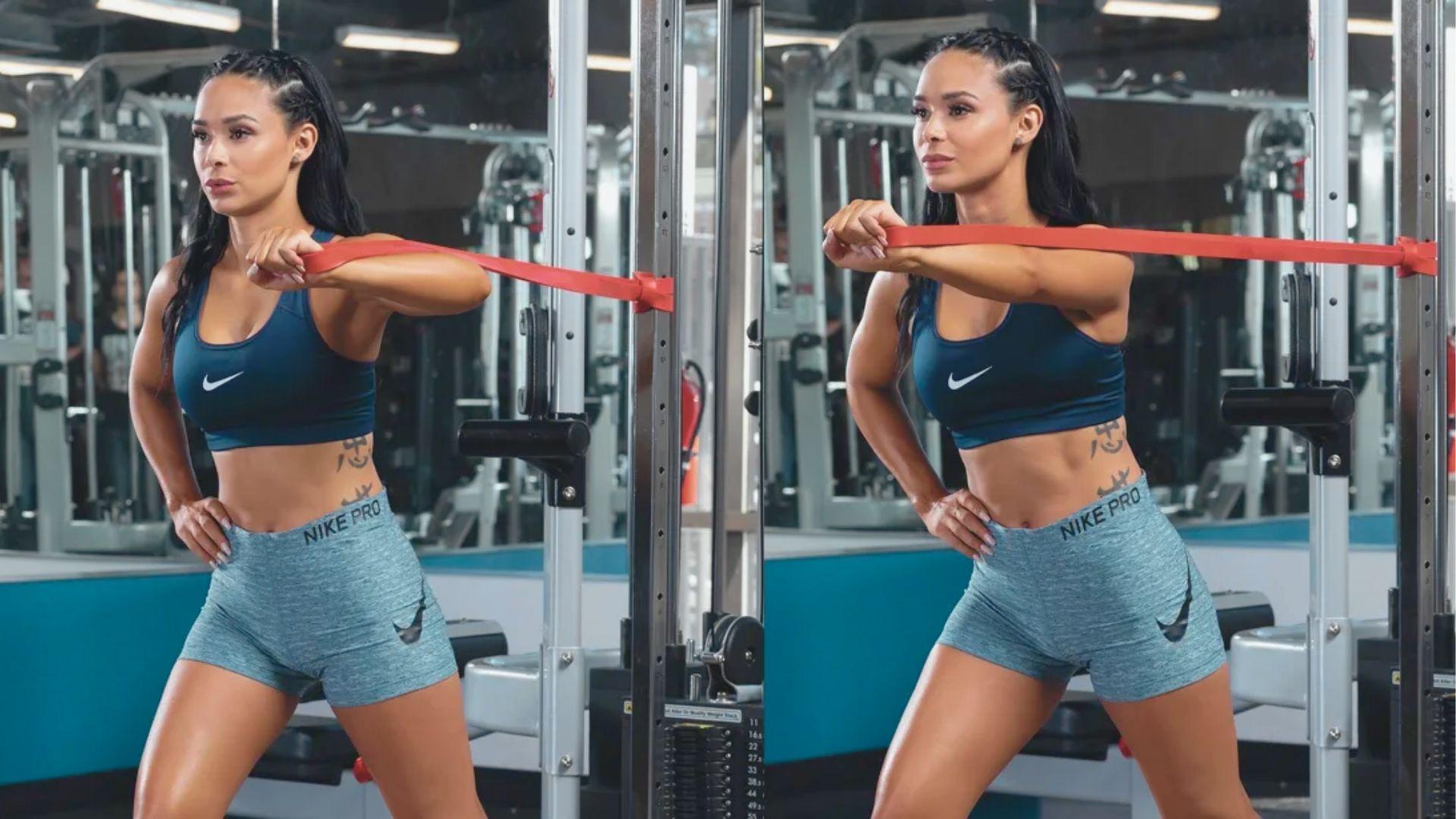 Woman in a blue Nike set shown in a split view, pressing a resistance band forward with one arm at chest height.