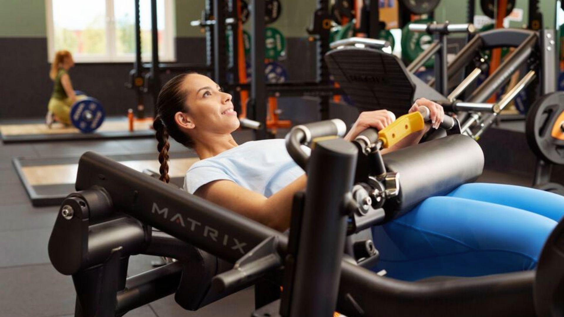 A person performing hip thrusts on a bench in a gym, focusing on glute activation during the lift.