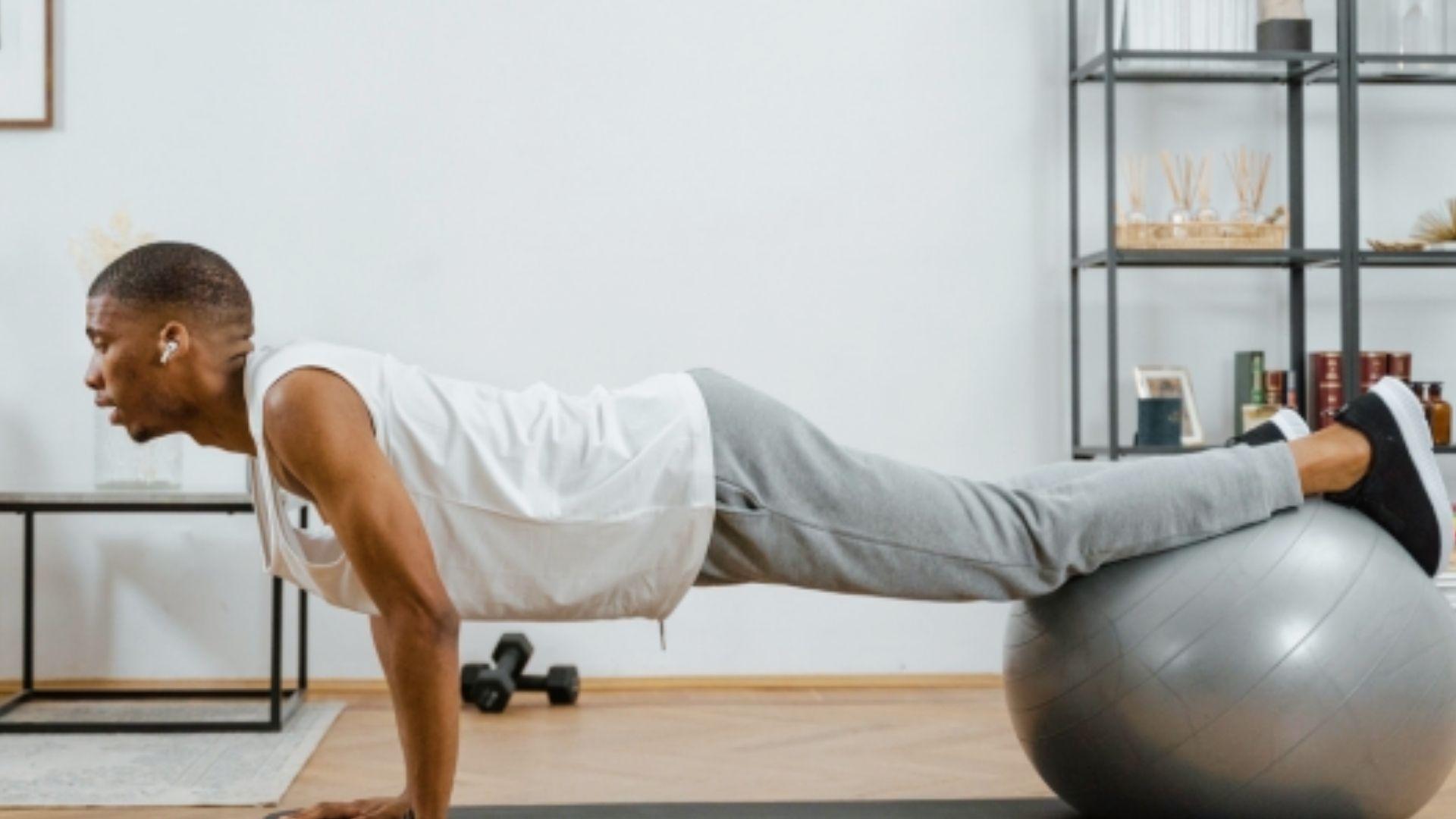 Person performing a stability ball hamstring curl exercise to improve balance and stability