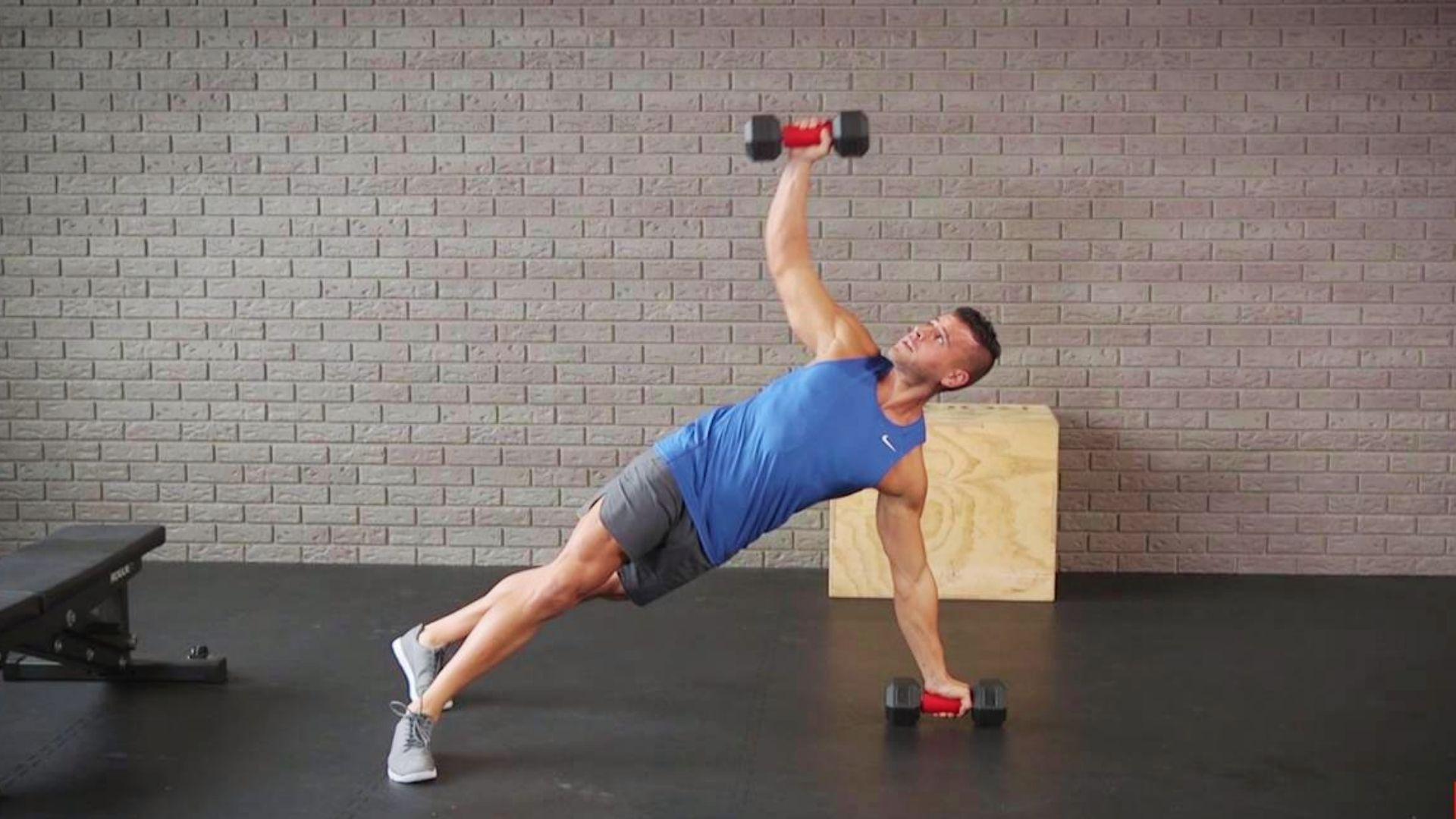 Person performing dumbbell push-ups on the floor for deeper chest activation and added resistance