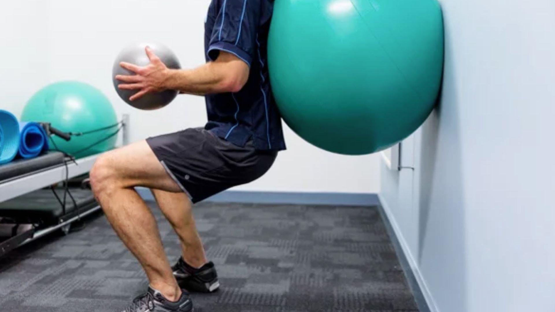 Person performing a stability ball hamstring curl exercise to strengthen the posterior chain muscles.