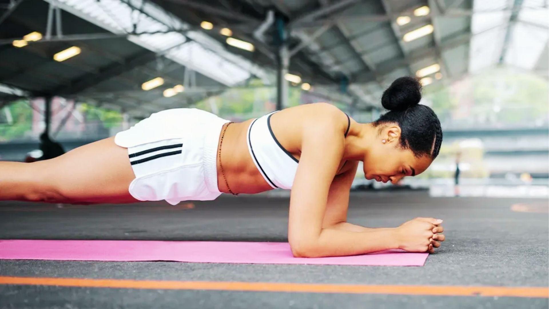 Person performing a core workout exercise on a gym mat.