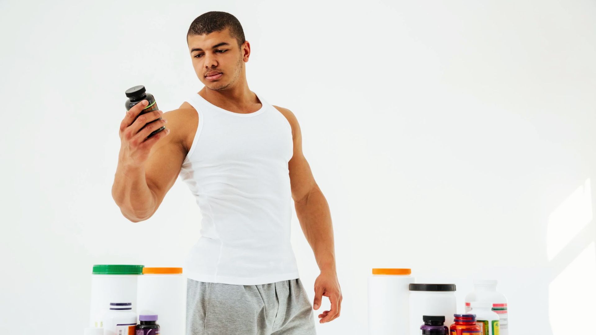 A person holding a pre-workout supplement representing choosing the right product for weight loss support.