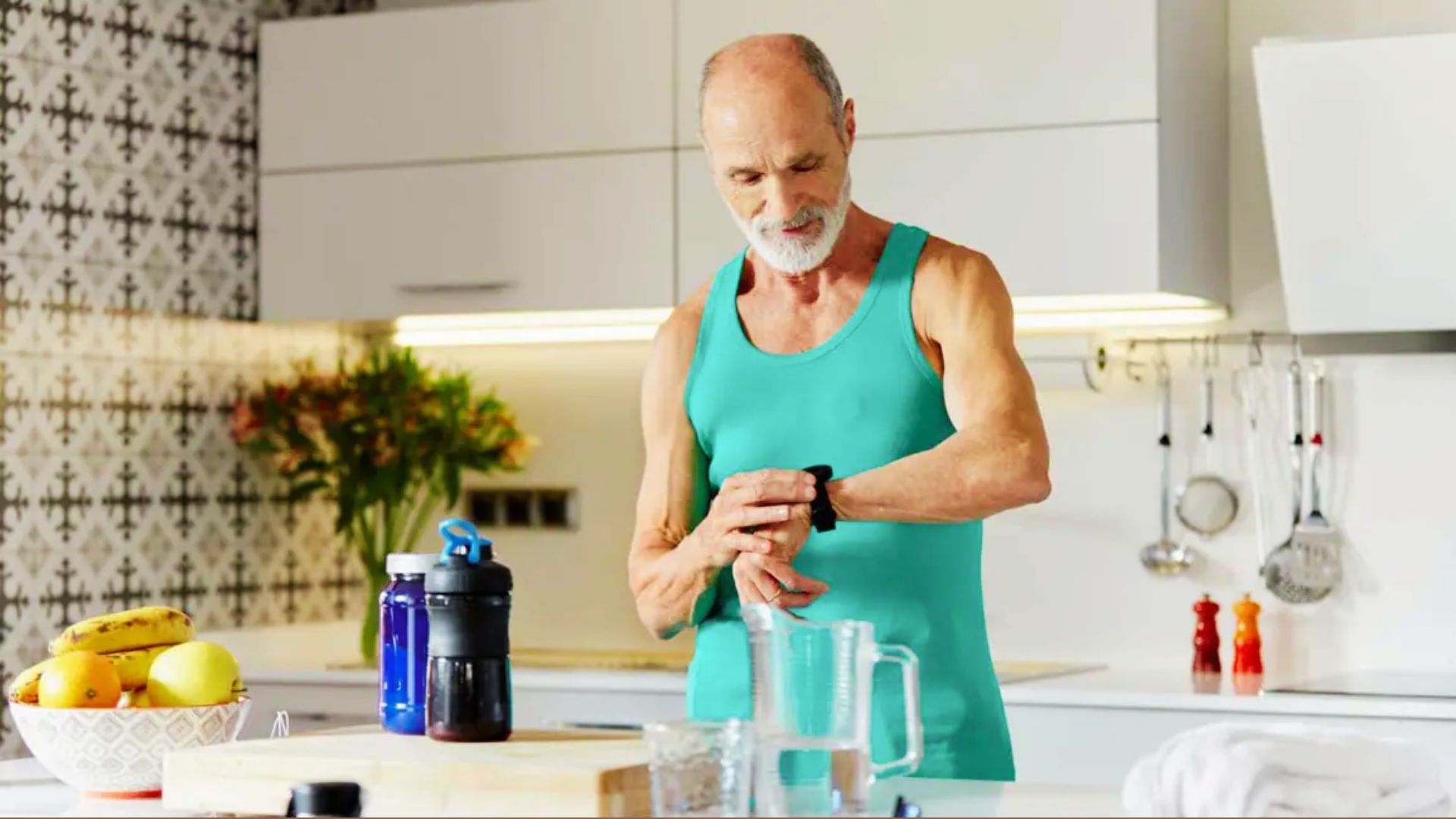 A person standing in the kitchen looking at their wristwatch, showing attention to timing or a scheduled routine.