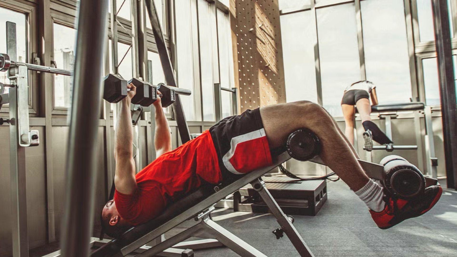 Person performing decline dumbbell press on a decline bench targeting lower chest muscles
