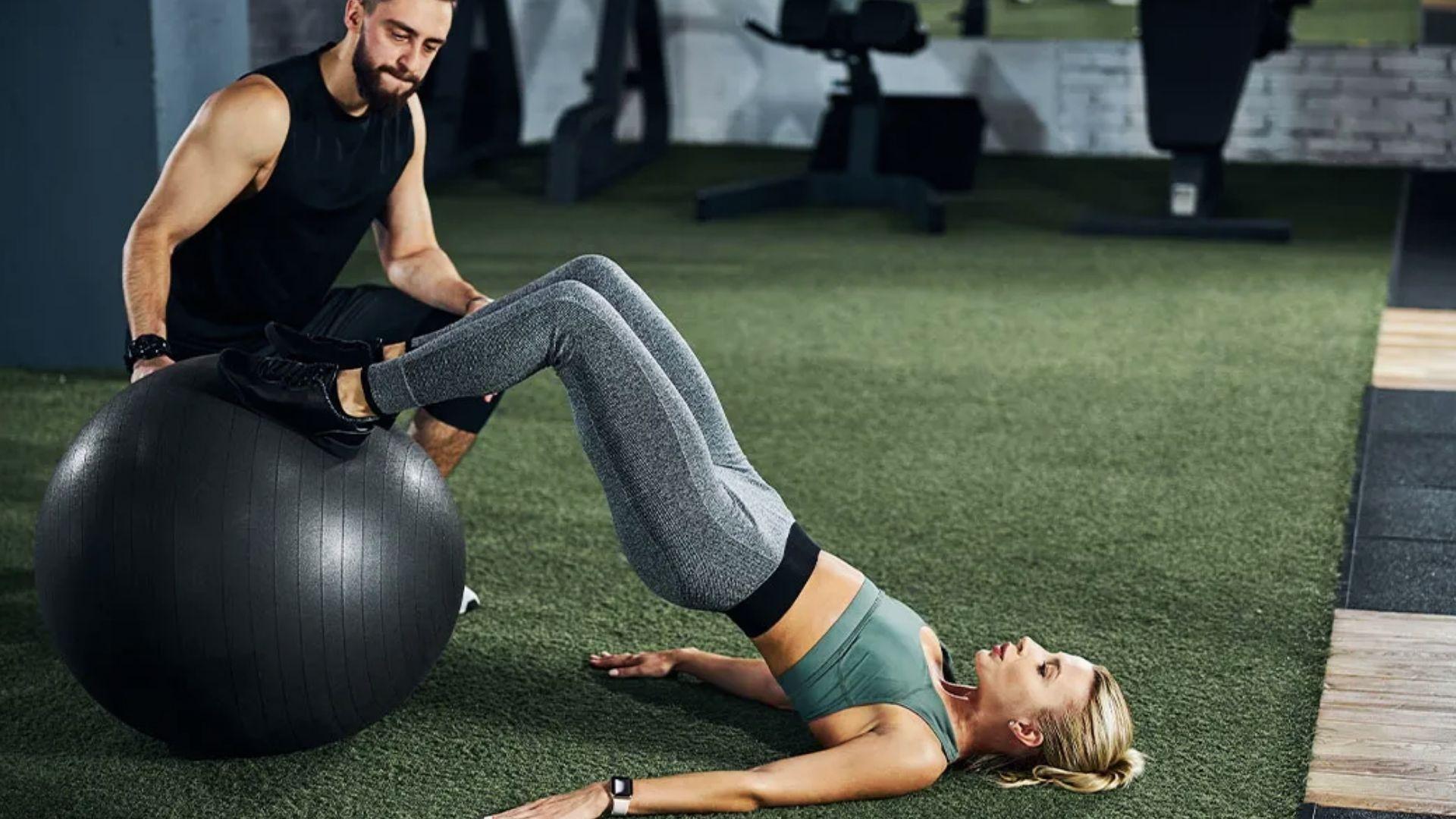 Person performing a stability ball hamstring curl exercise to strengthen the hamstrings.