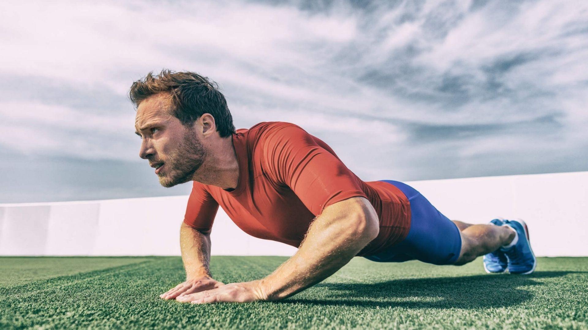 Person performing diamond pushups to build triceps and chest strength.