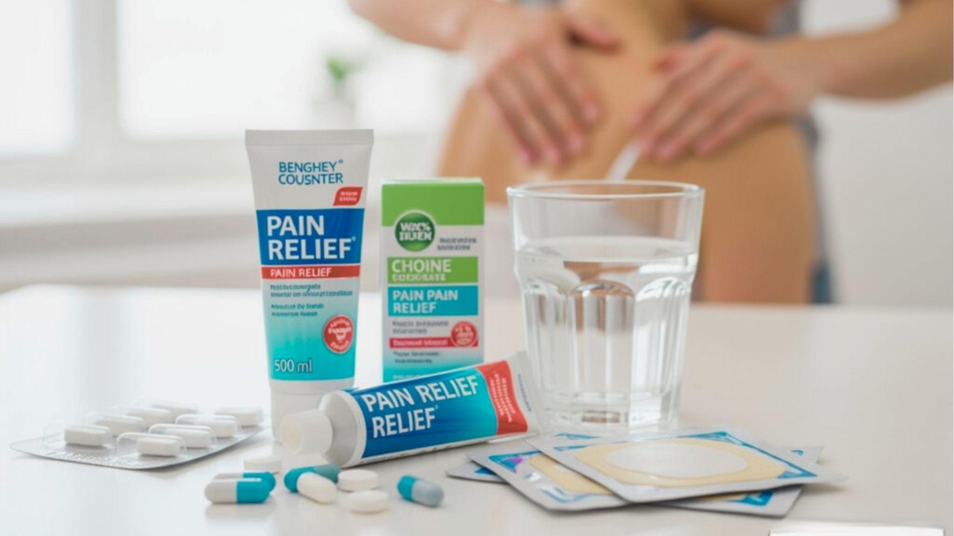 Pain relief creams, pills, patches, and a glass of water are on a table while someone holds their back in the background.