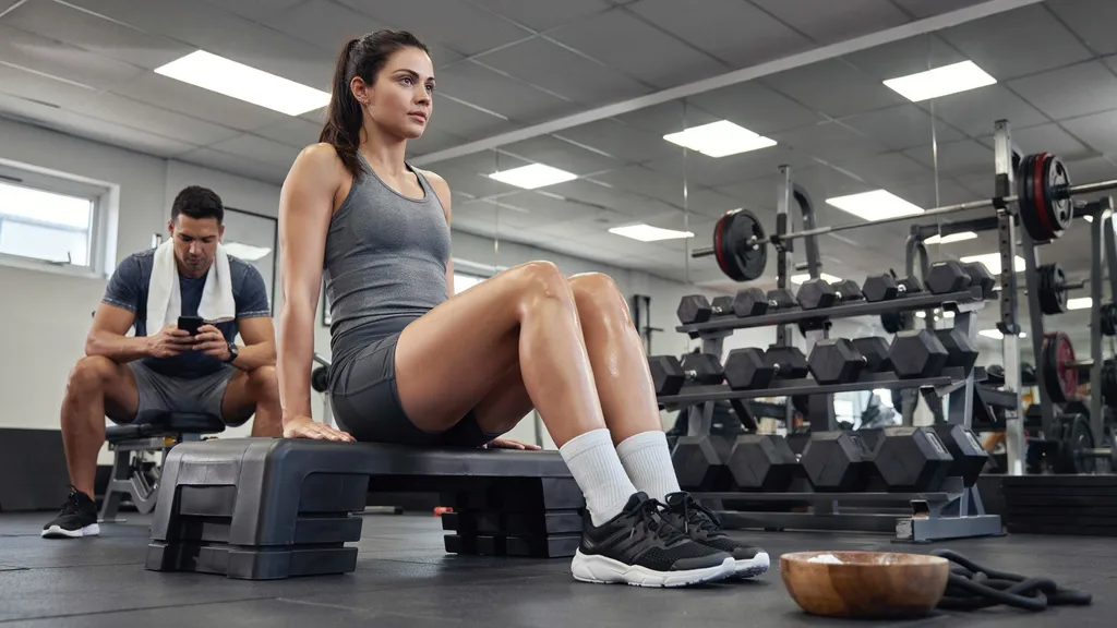 Woman doing calf raises on an elevated step.