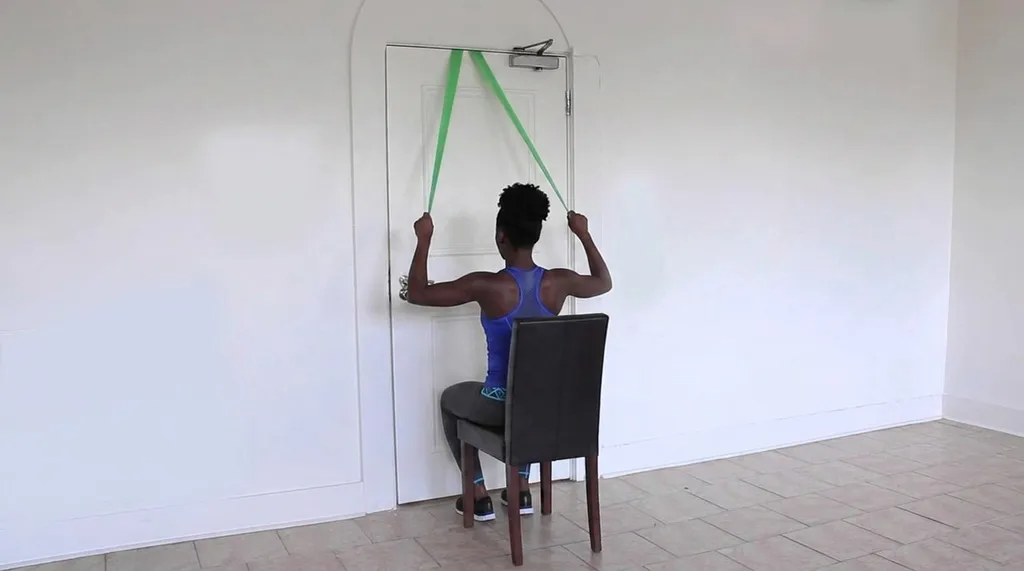 A person is doing Banded Lat Pulldown with the help of chair