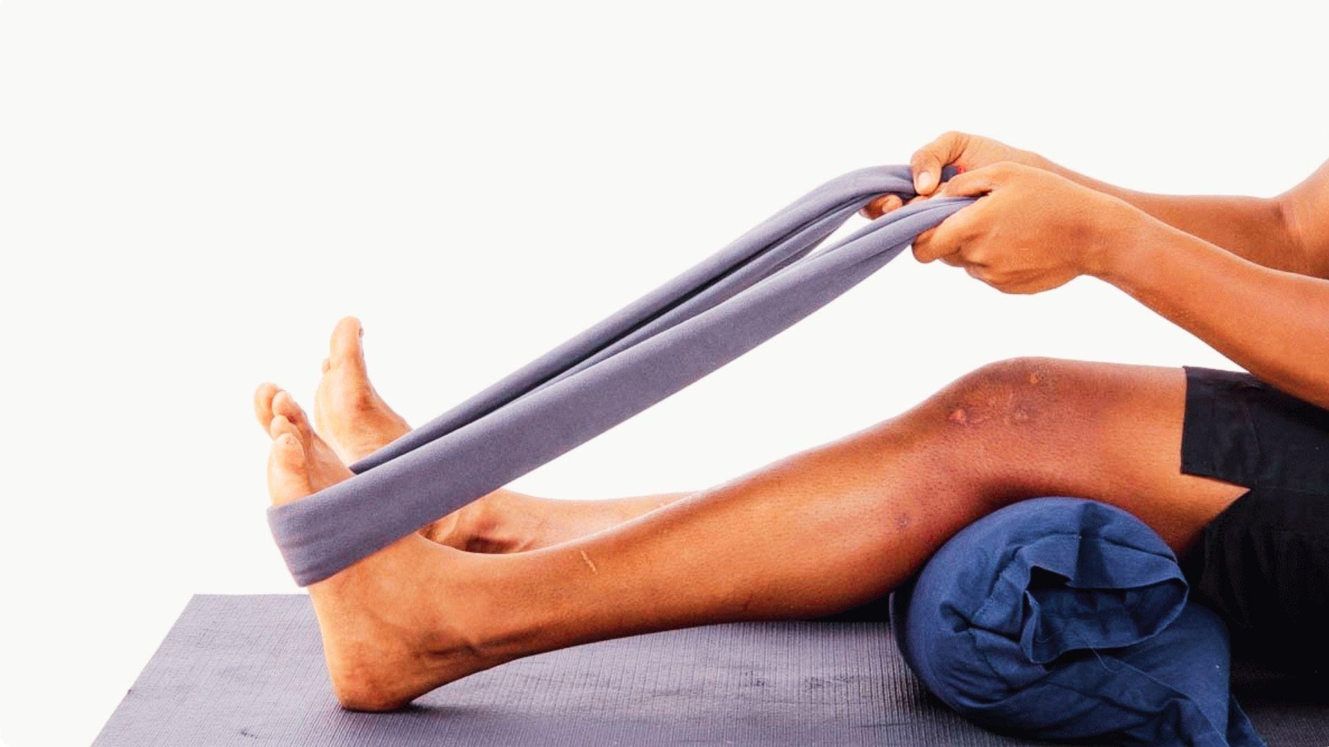 Towel stretch exercise for calf flexibility and ankle tension relief by pulling it.