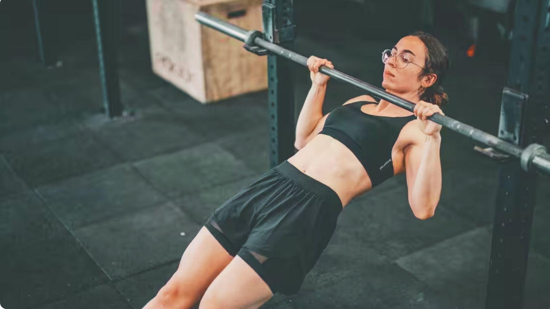 Athlete performing Australian rows under a low bar to develop horizontal pulling strength.