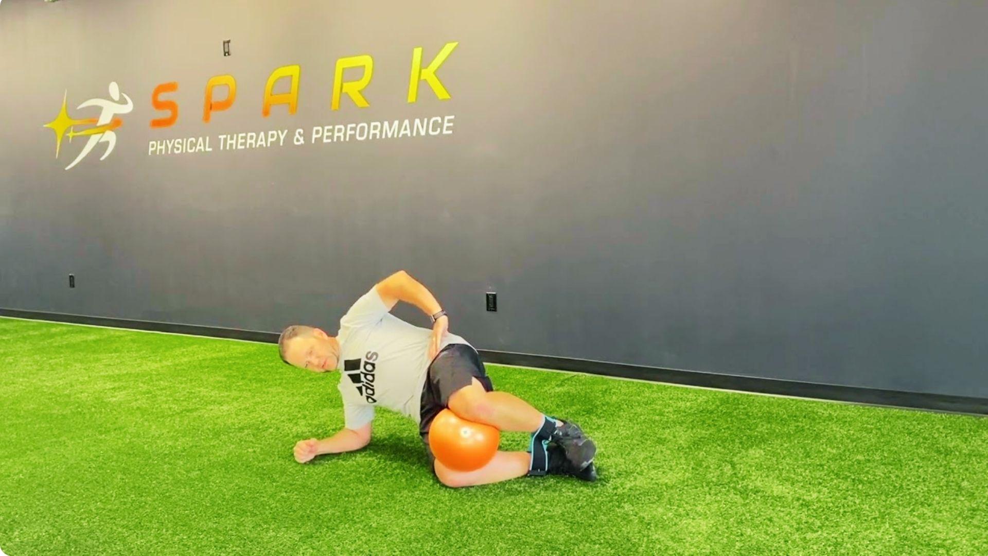 Stability ball clam shell exercise improving core balance and glute activation on unstable surface