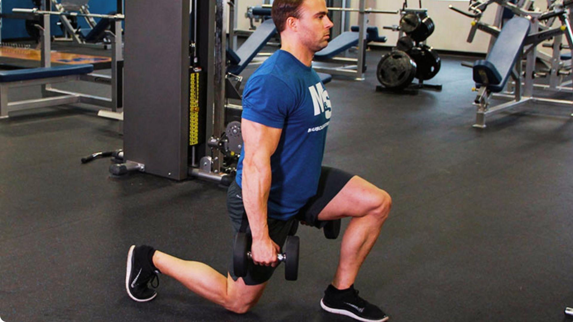 Person performing walking lunges with dumbbells, stepping forward to strengthen the legs and improve balance.