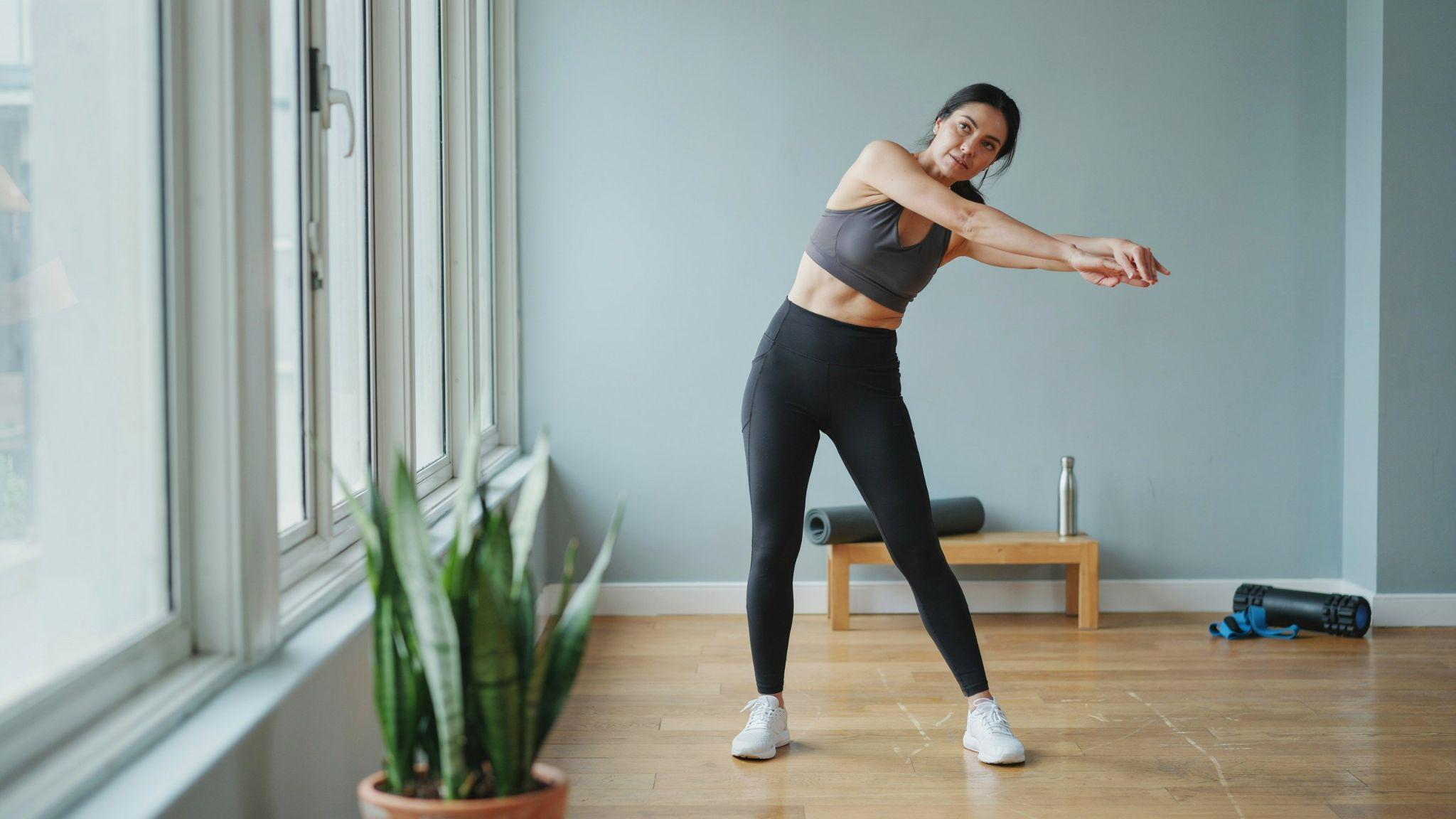 Person performing dynamic back stretching movements to improve mobility and prepare for exercise