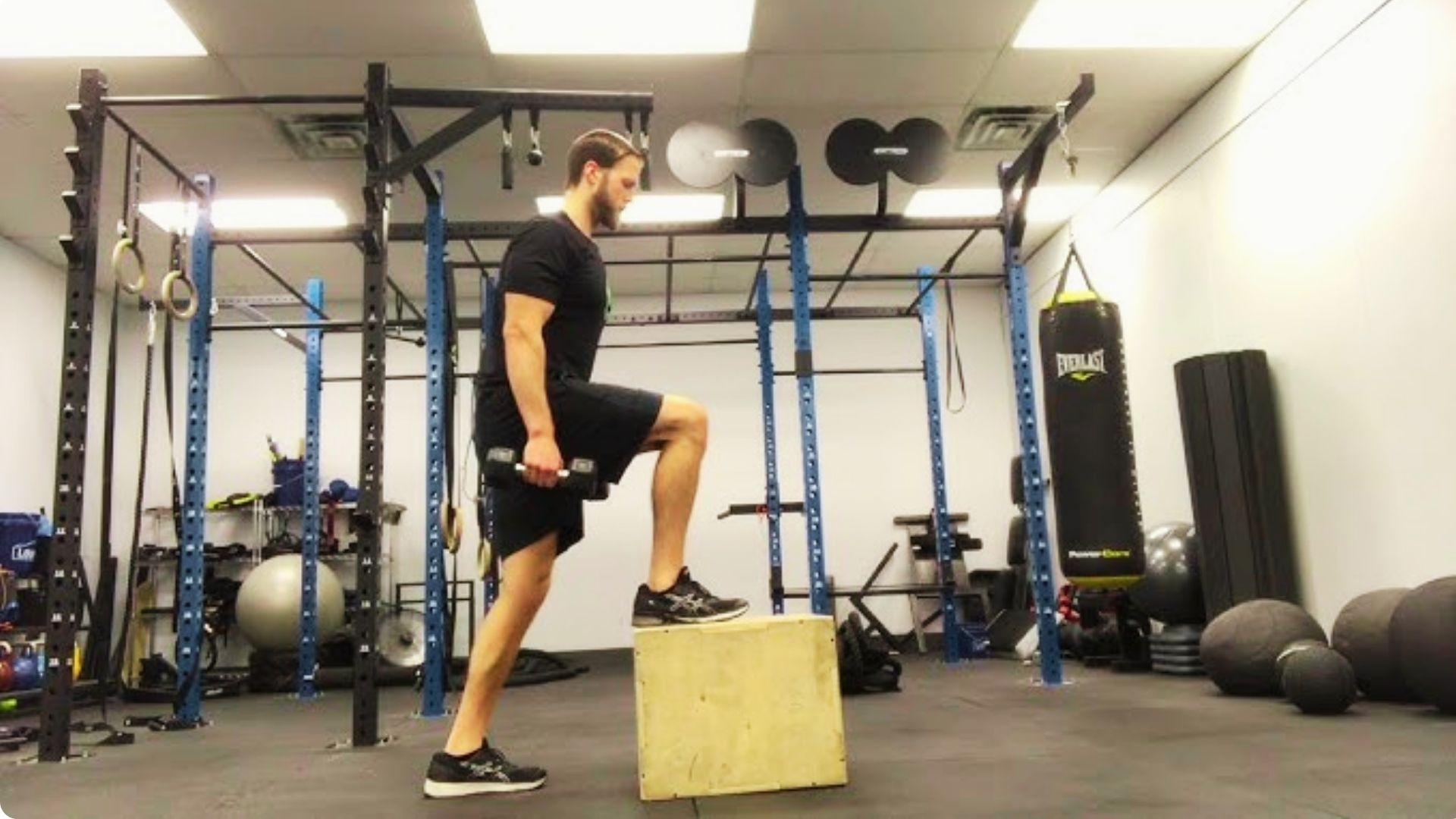 Fitness enthusiast stepping onto a bench during step-up exercises to improve leg strength and coordination.